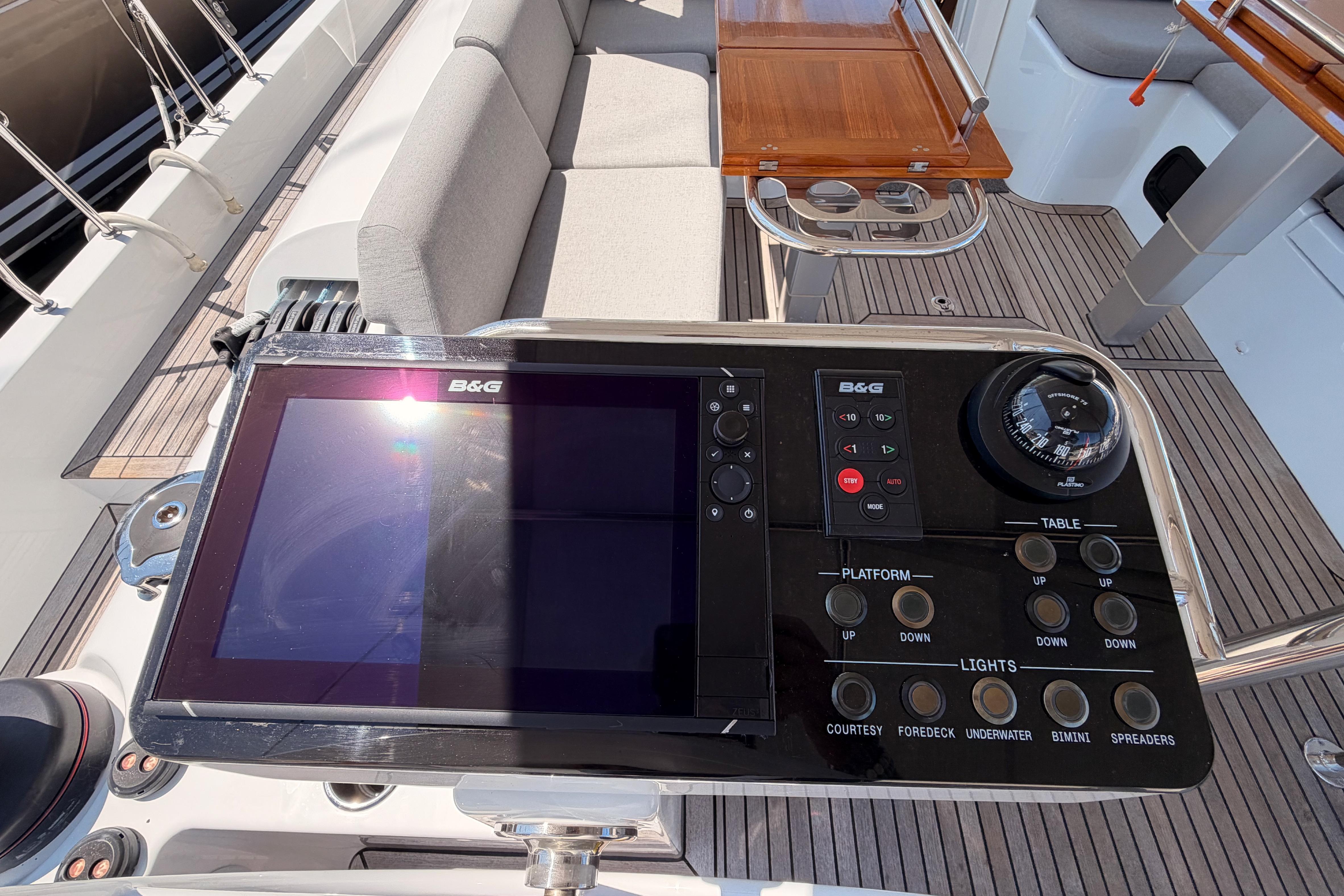 Control panel on 2022 Beneteau Oceanis Yacht 54 with navigation and seating area.