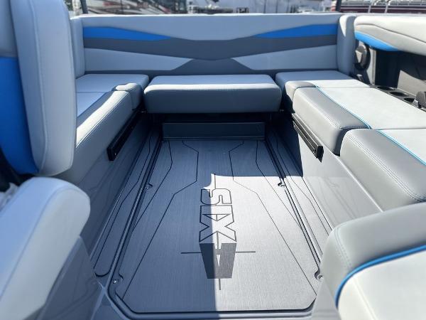 2025 Axis A225 boat interior with gray and blue seating, featuring "Axis" branding on the floor.