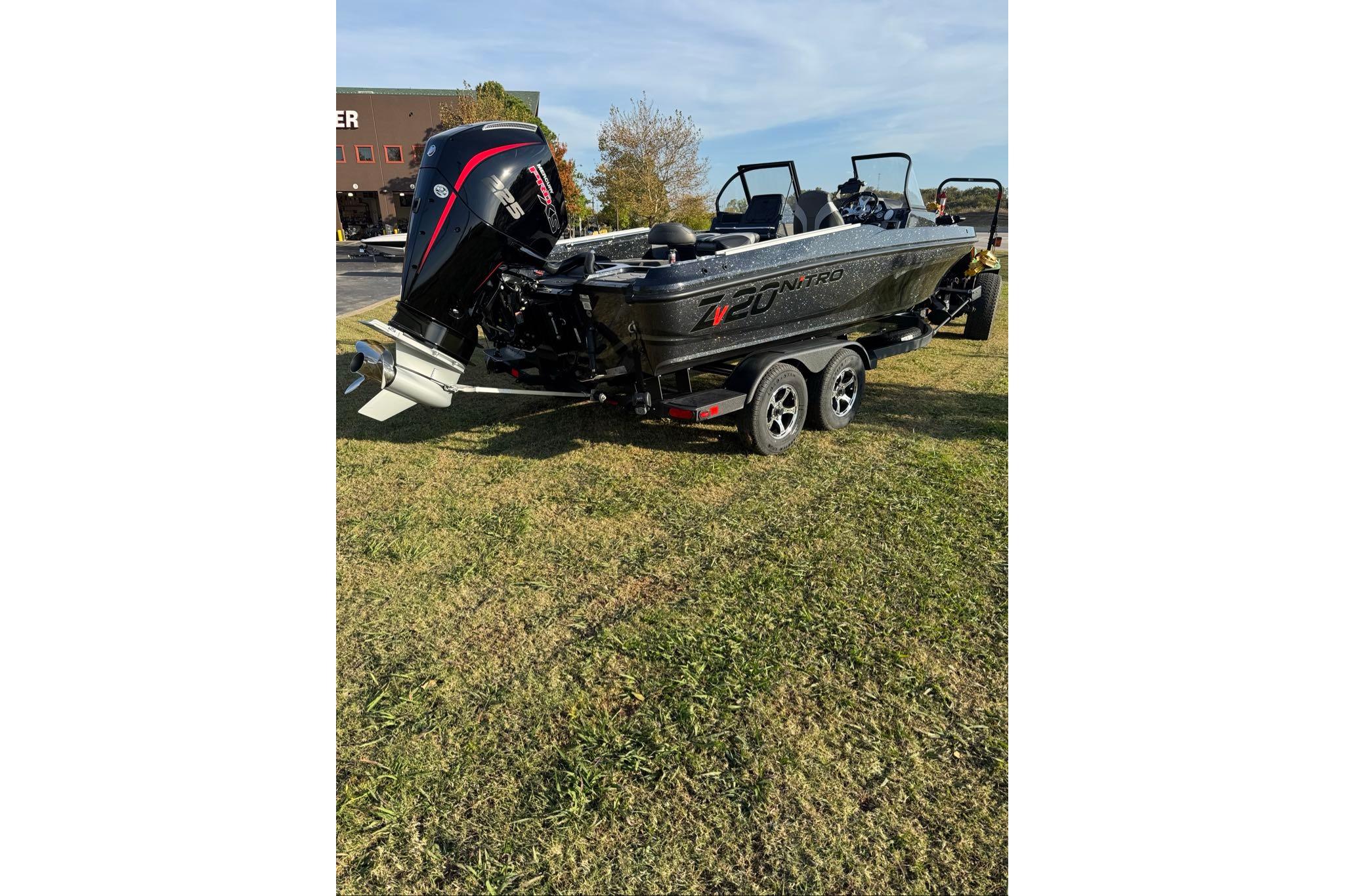 2026 Nitro ZV20 Pro boat on trailer, parked on grass, with powerful outboard motor.