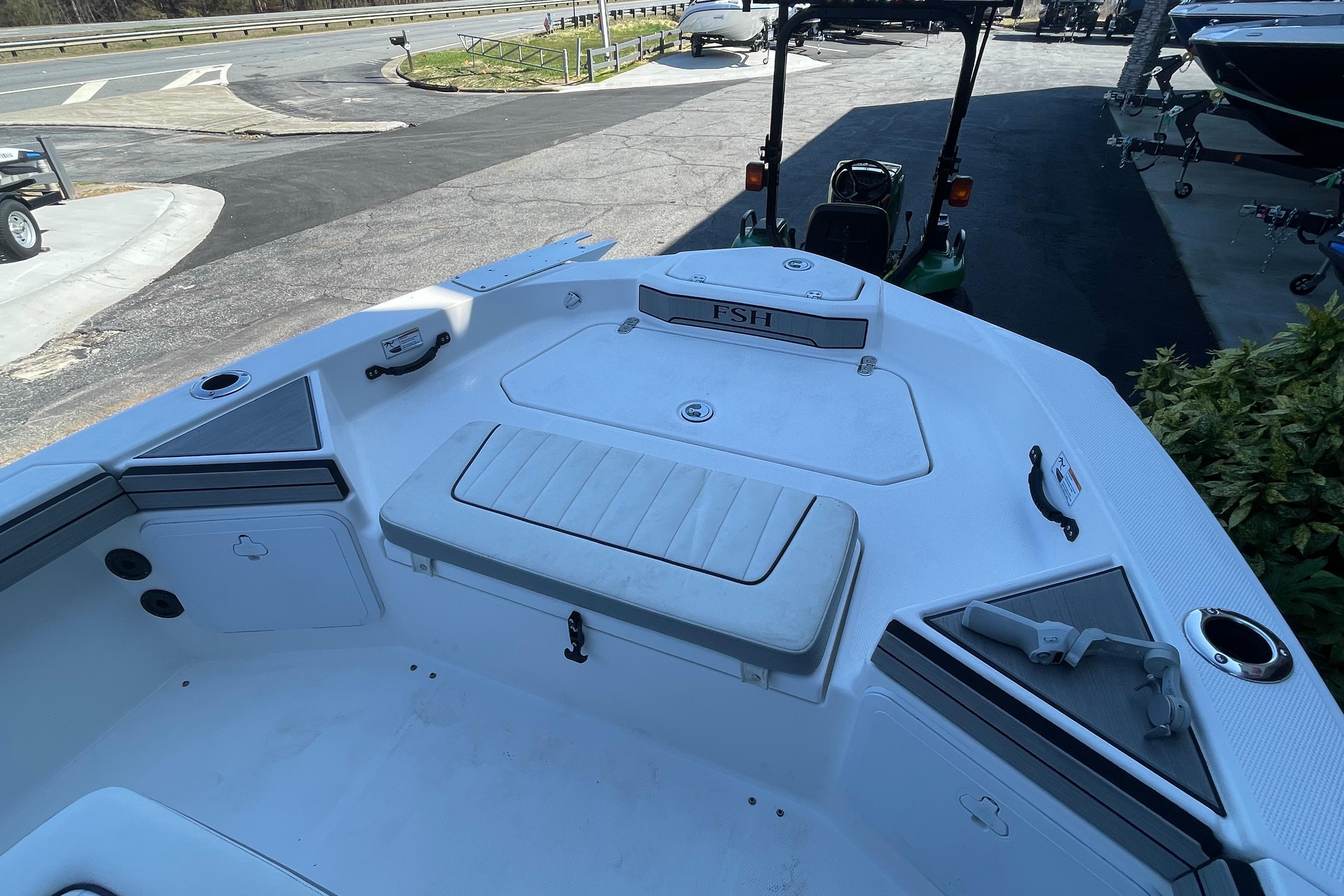 2021 Yamaha Boats 195 FSH Sport interior, featuring seating and storage compartments.