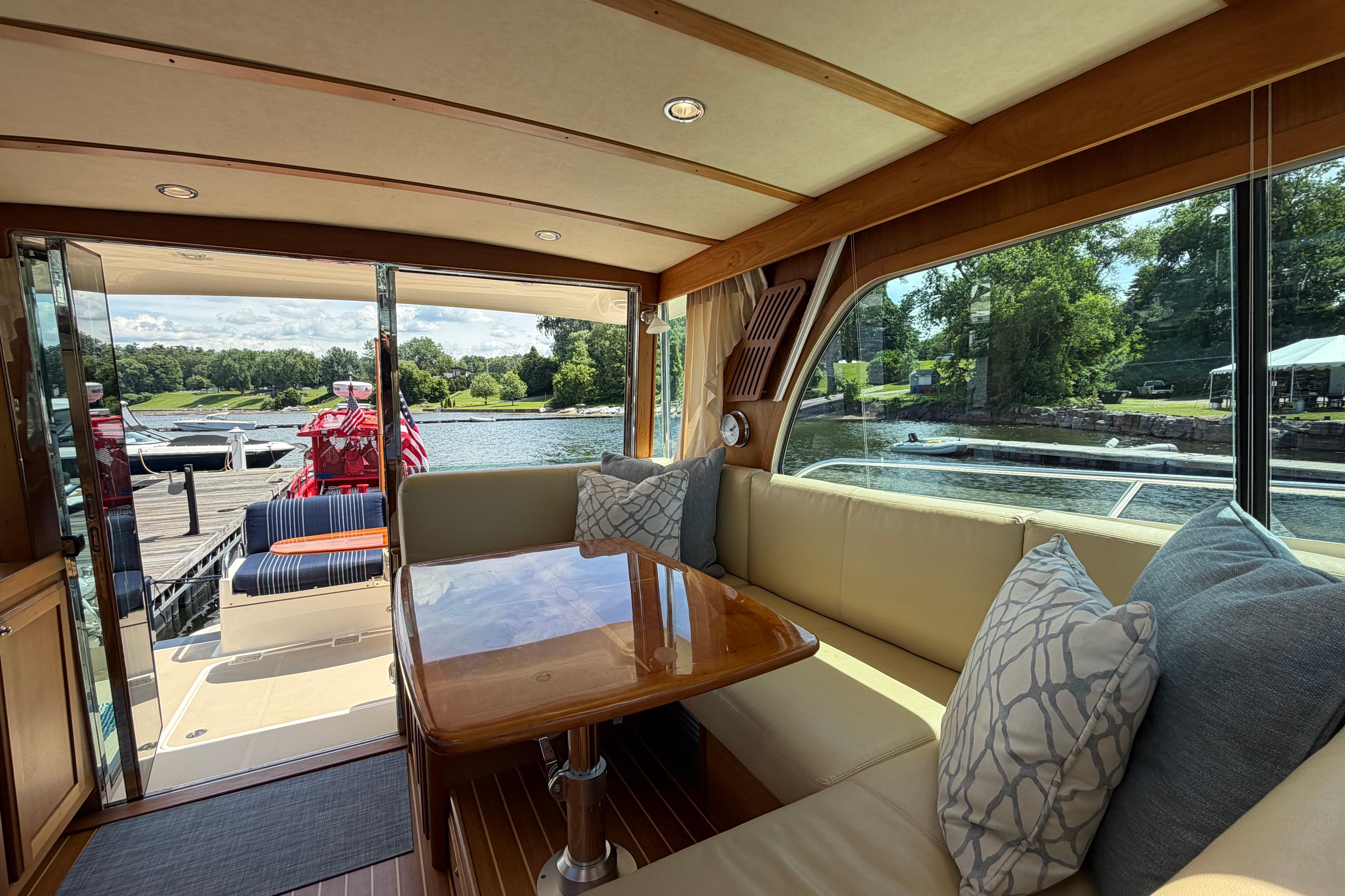 Interior of 2015 Sabre 38 Salon Express yacht with elegant seating and scenic water view.
