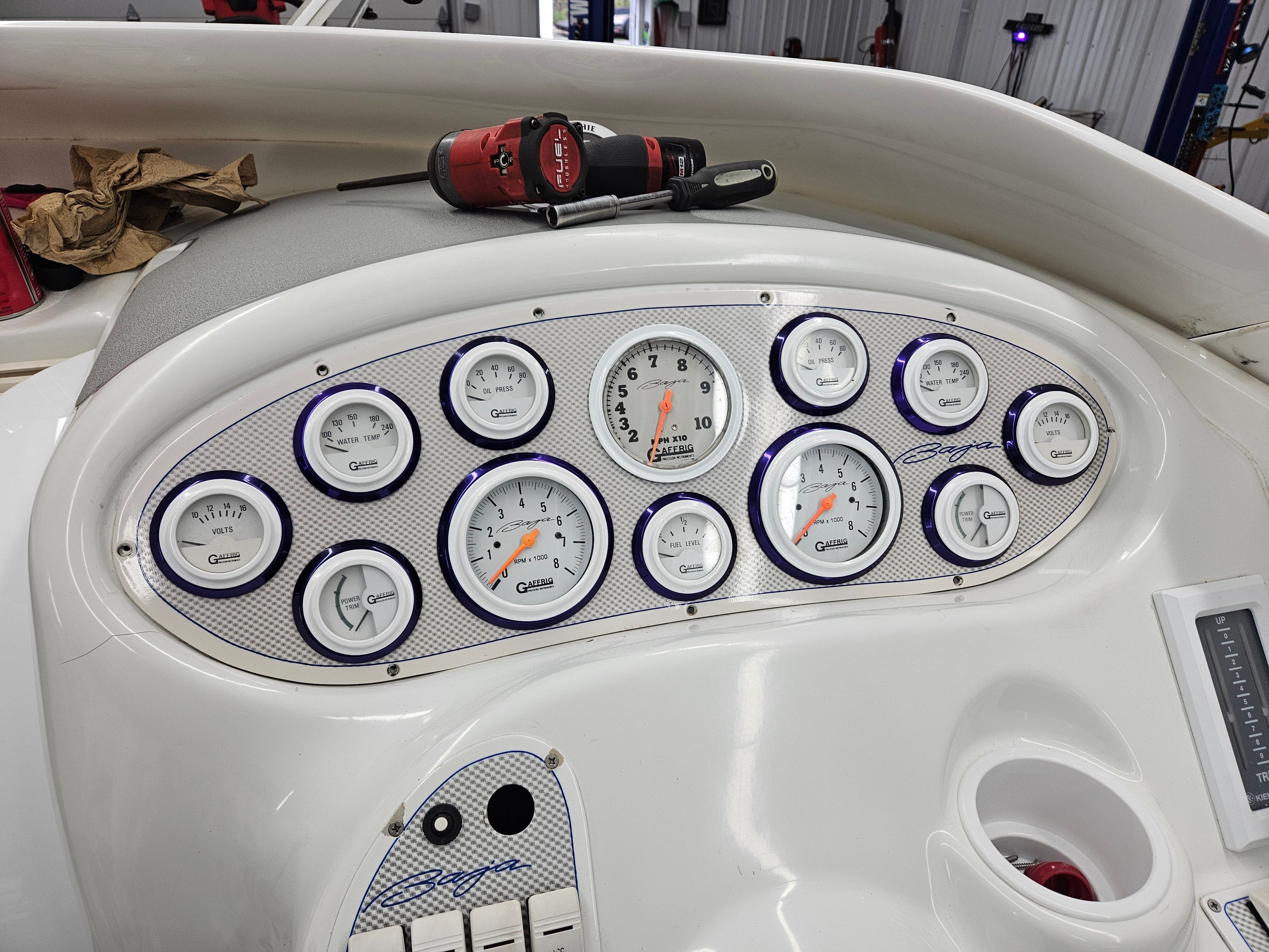 The dashboard of a 1996 Baja 302 Boss features multiple analog gauges and switches.