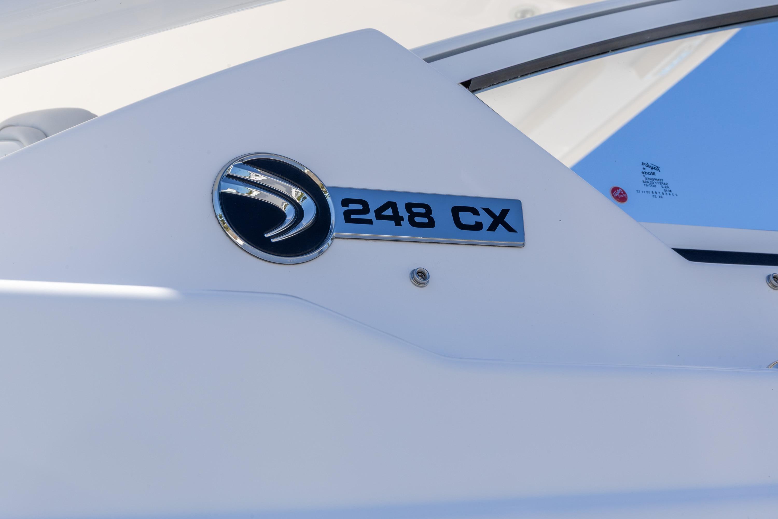 2026 Edgewater 248CX Crossover boat emblem on white surface under blue sky.