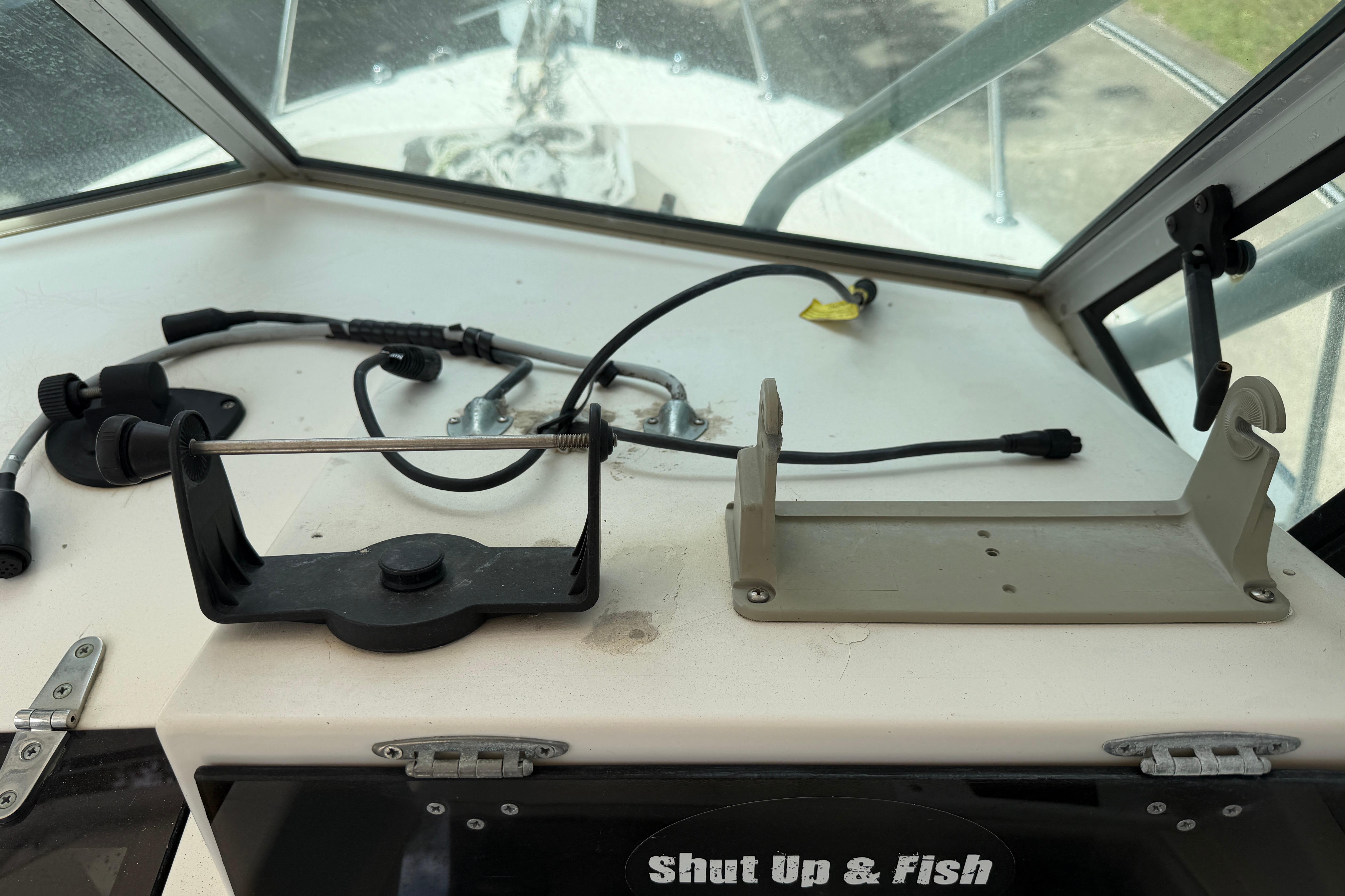 Dashboard of a 1987 Grady-White Seafarer 226 boat with fishing equipment mounts.