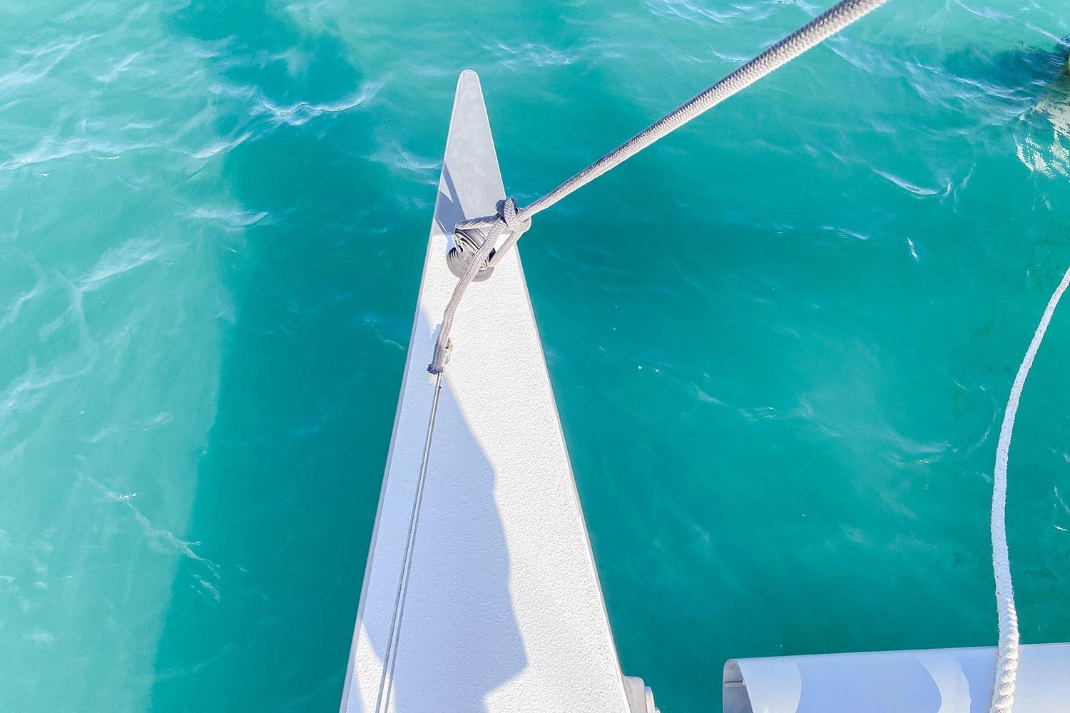 Bow of BBL CAT 54 boat on turquoise water, 2004 model.