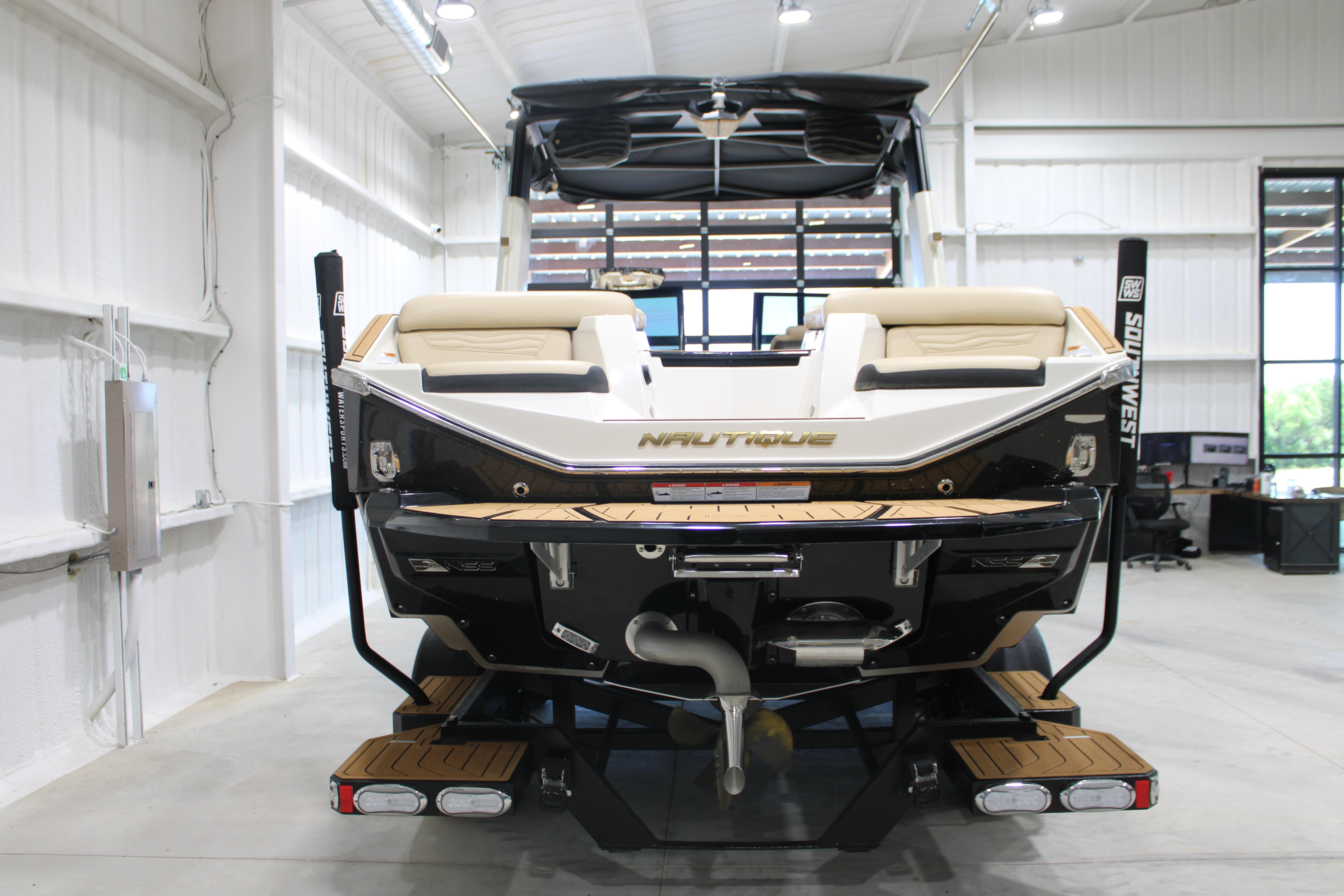 2025 Nautique Super Air Nautique G25 boat in showroom, rear view.