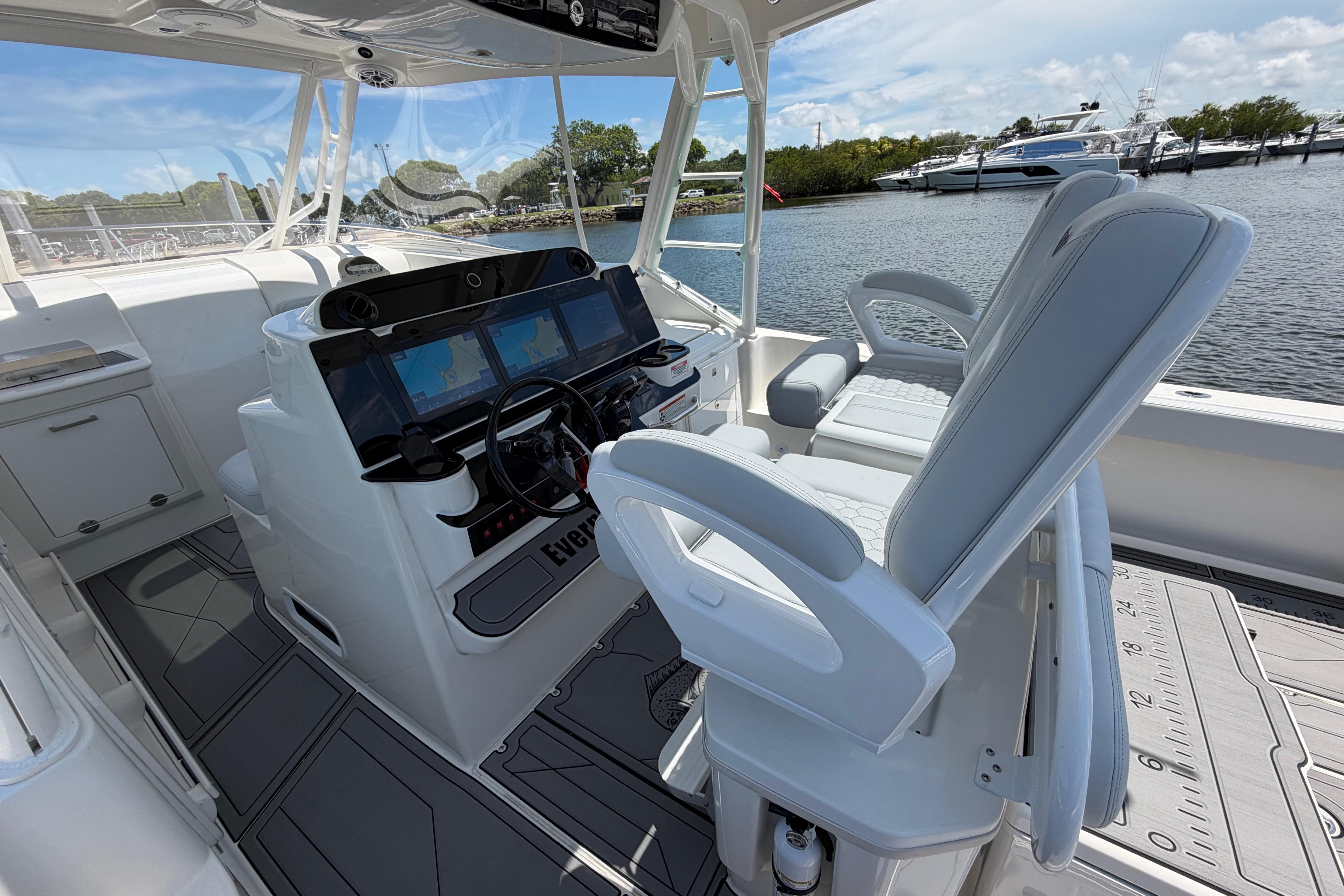 2009 Everglades 350LX boat interior with helm, navigation screens, and seating by the water.