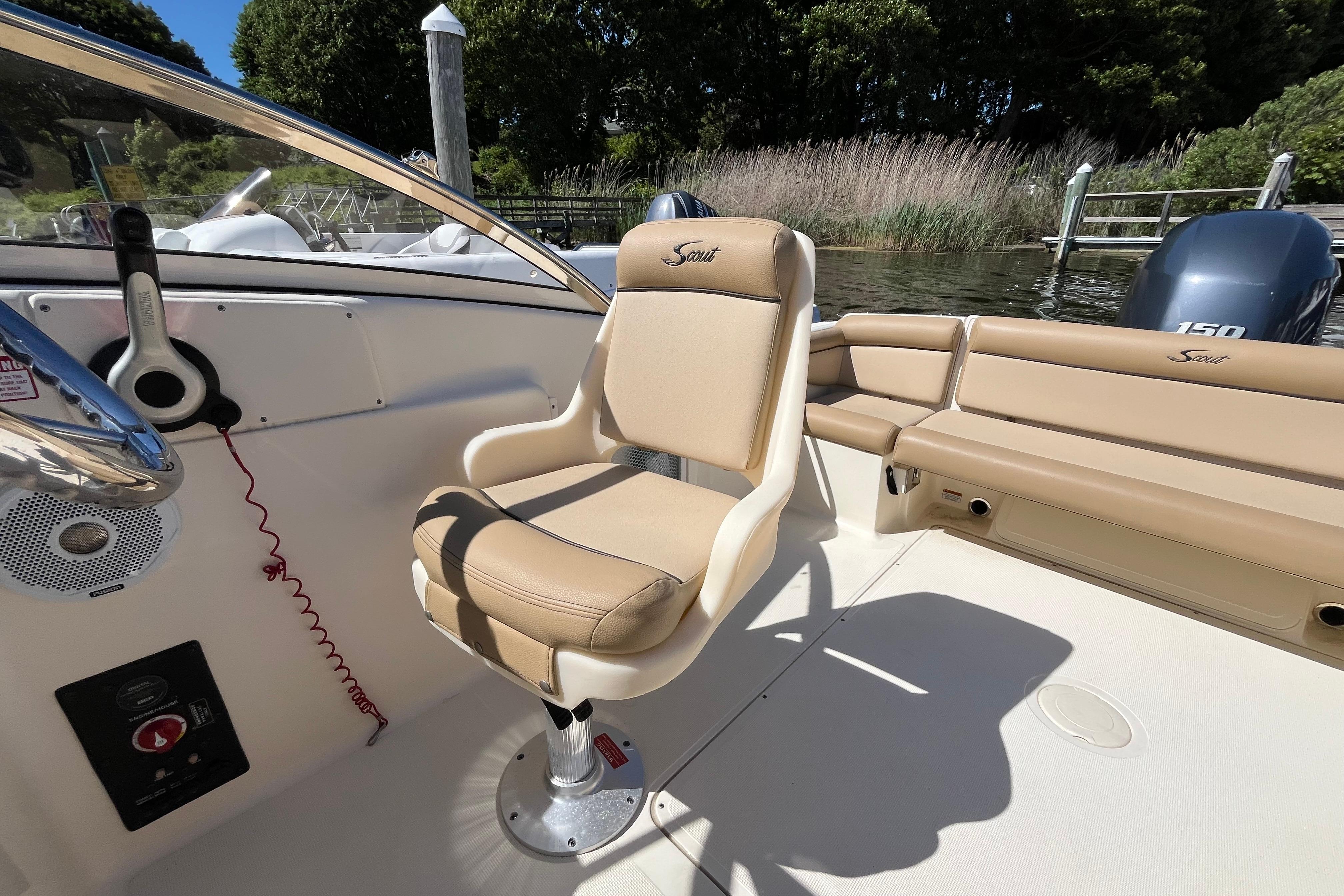 2017 Scout 210 Dorado boat interior with beige seating and steering console.
