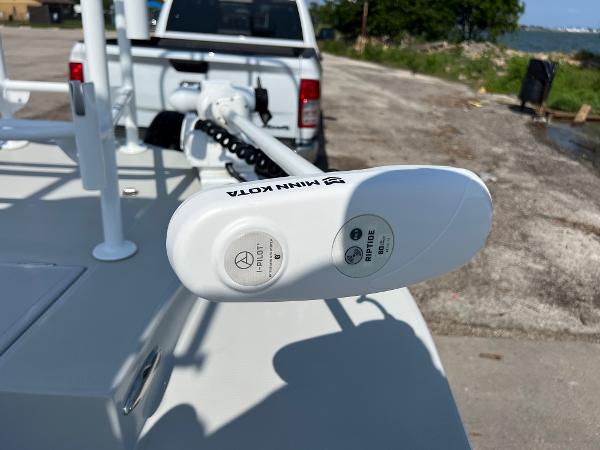 2022 Shallow Sport 20 Classic boat with Minn Kota trolling motor, parked near a waterfront.