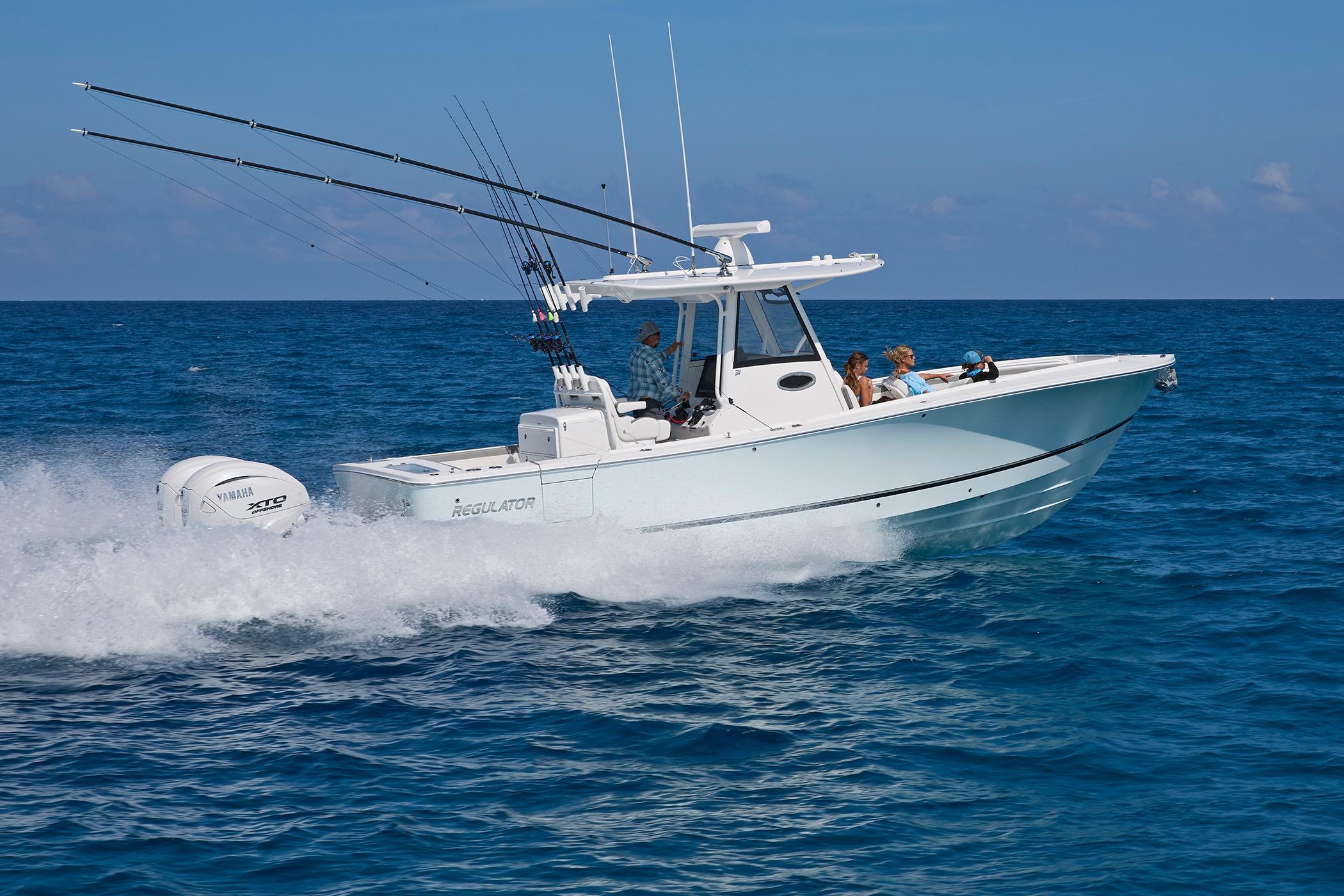 2025 Regulator 31 boat cruising on open ocean with fishing rods and Yamaha engine.