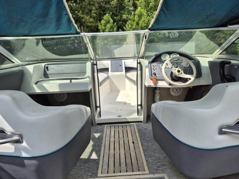 Interior view of a 1996 Cobalt 220 boat with two seats and a helm station.