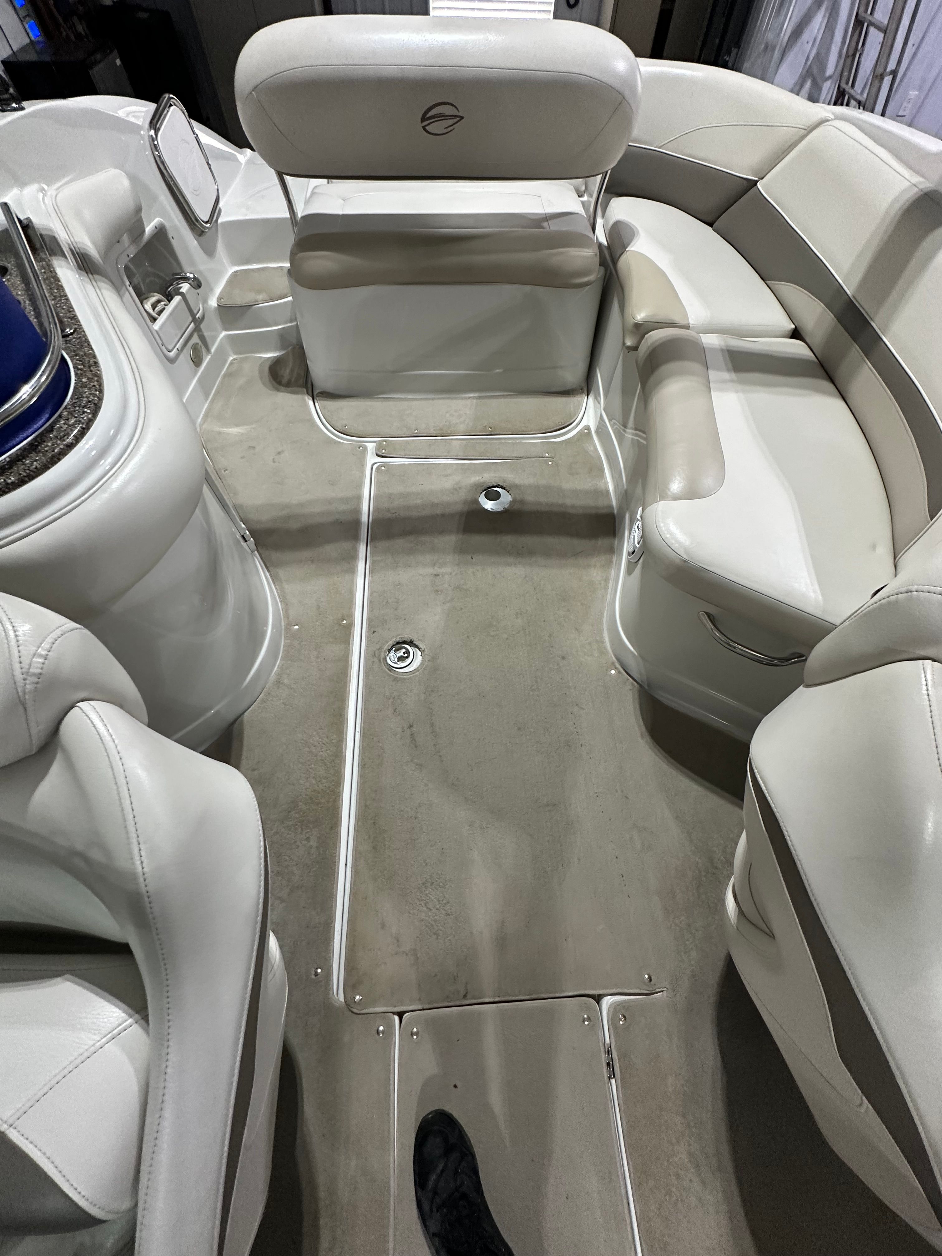 Interior of a 2007 Crownline 252 EX with beige seating and carpeted floor.