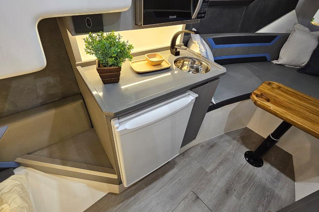 Compact kitchen area in a 2026 Hanover 327, featuring modern amenities and sleek design.