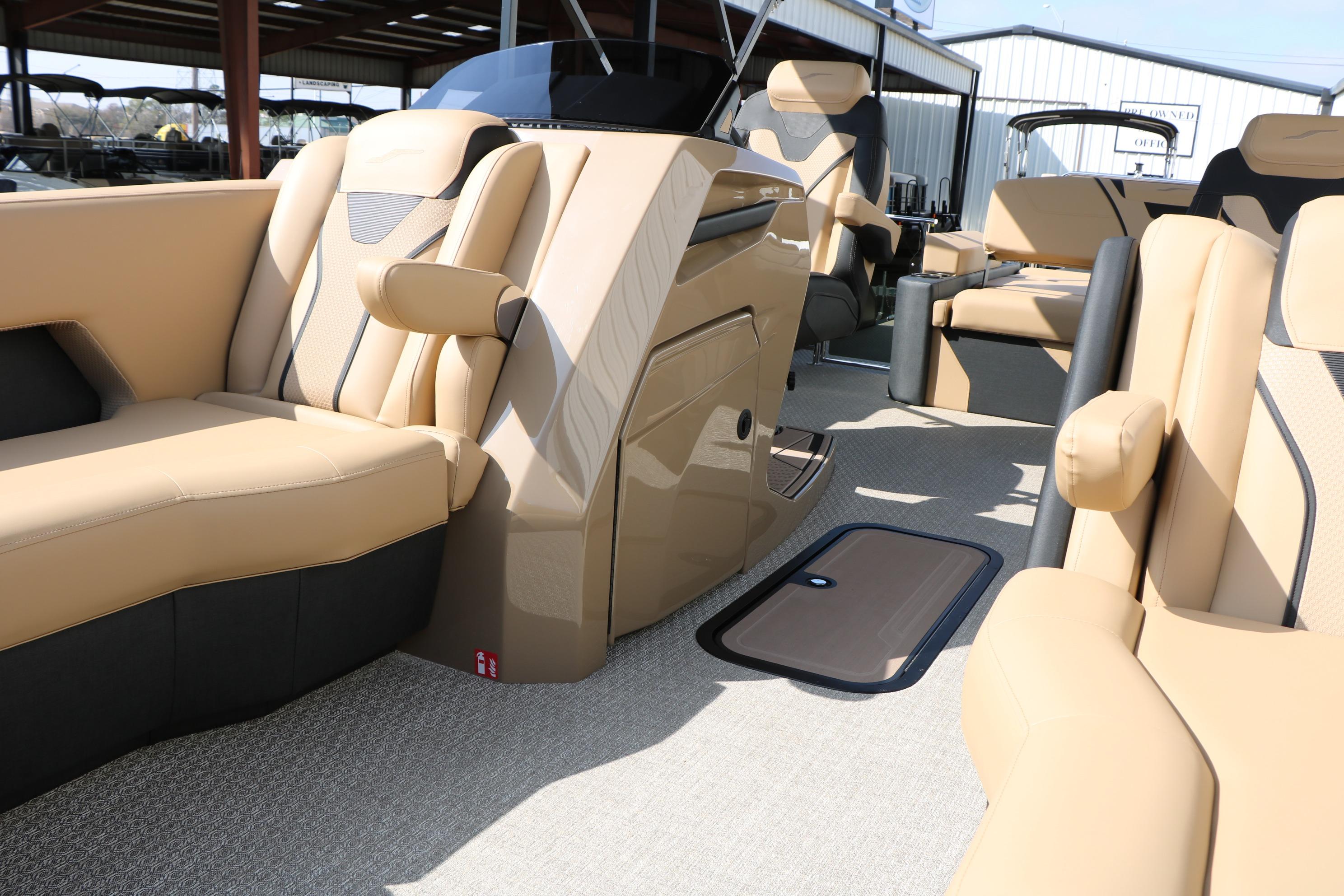 Luxurious interior of 2026 Evotti 723CS boat with beige and black seating.