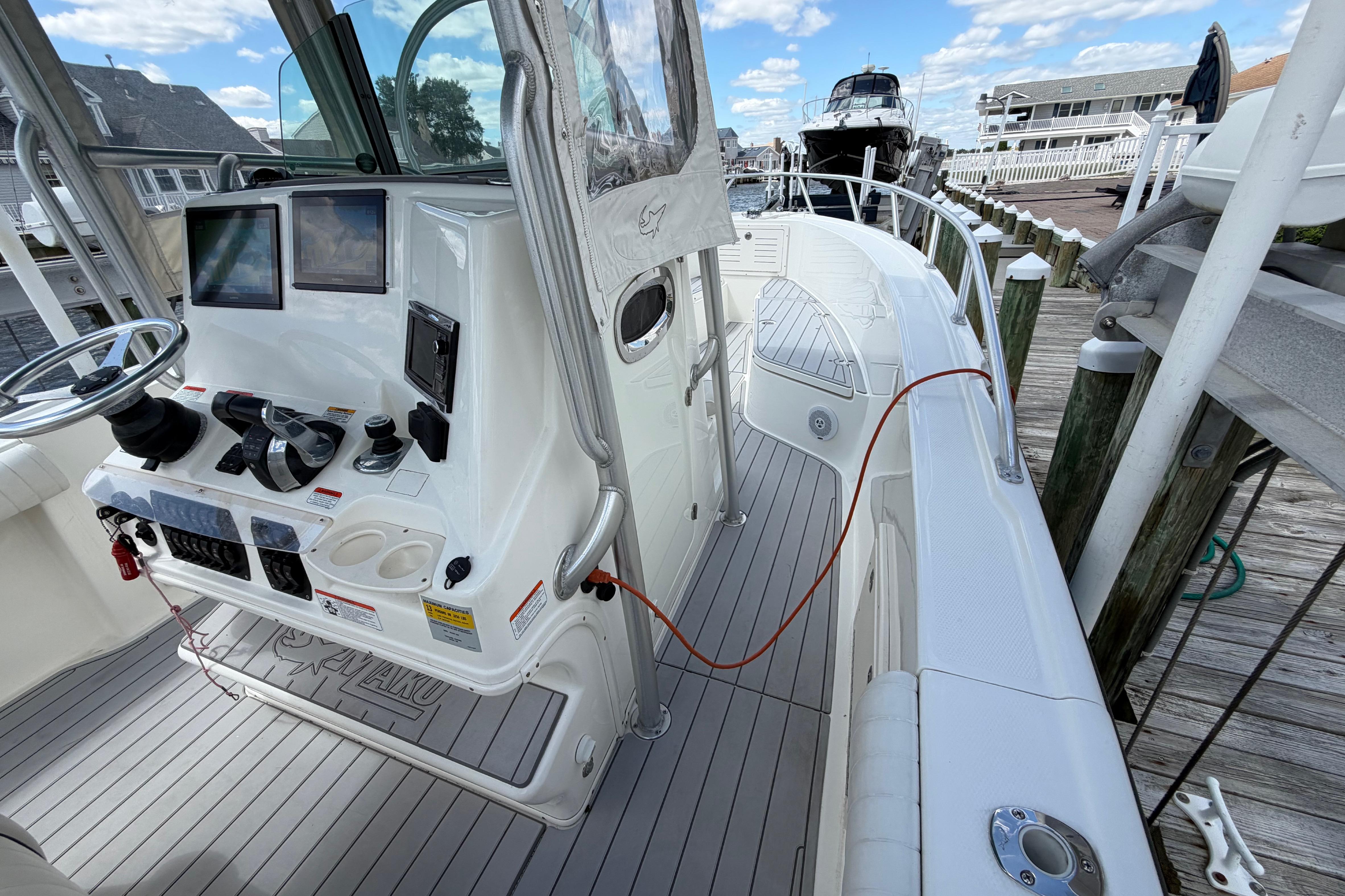 2017 Mako 284 Center Console boat docked, featuring modern controls and spacious deck.
