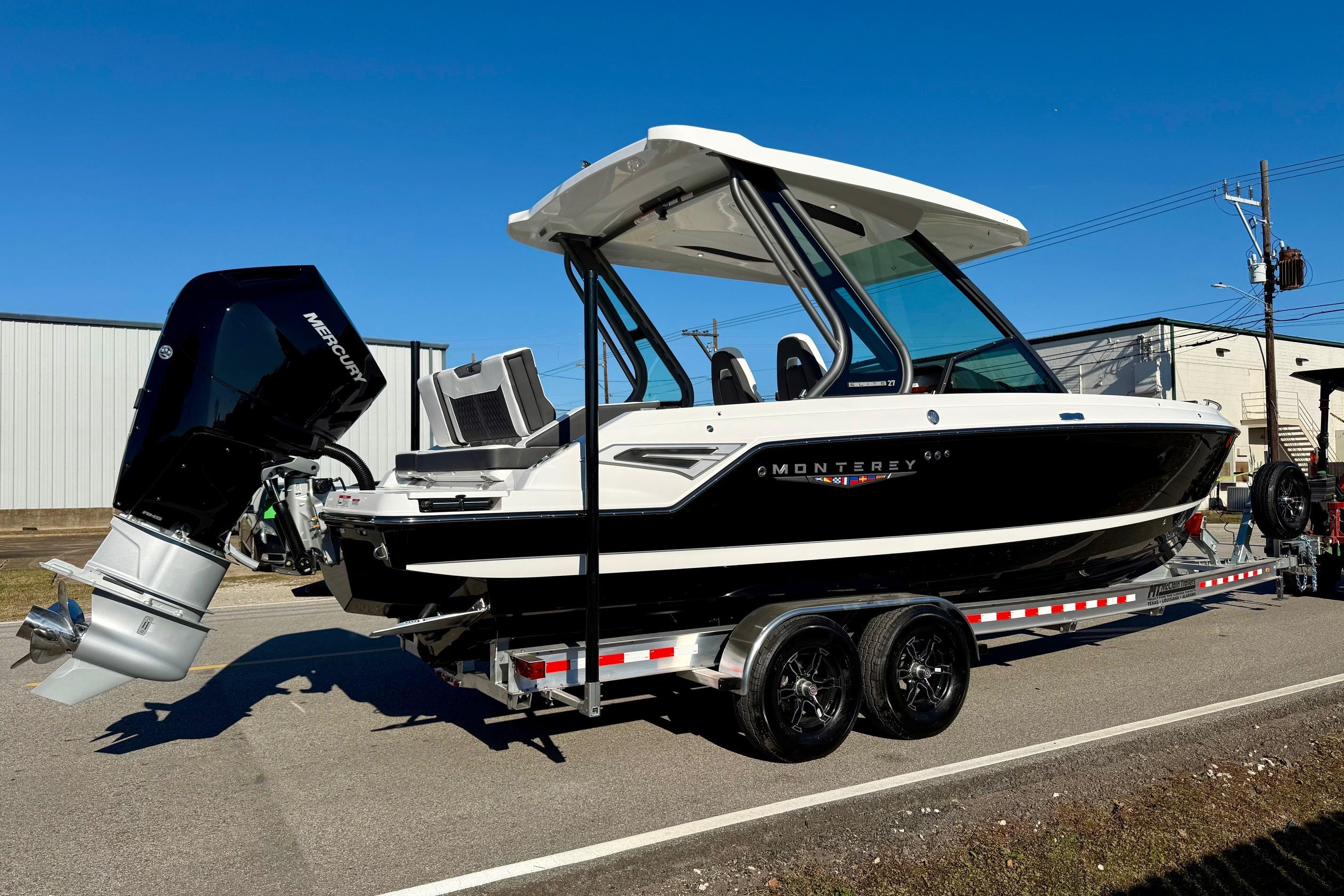 2026 Monterey Elite 27 OB boat on trailer, side view.
