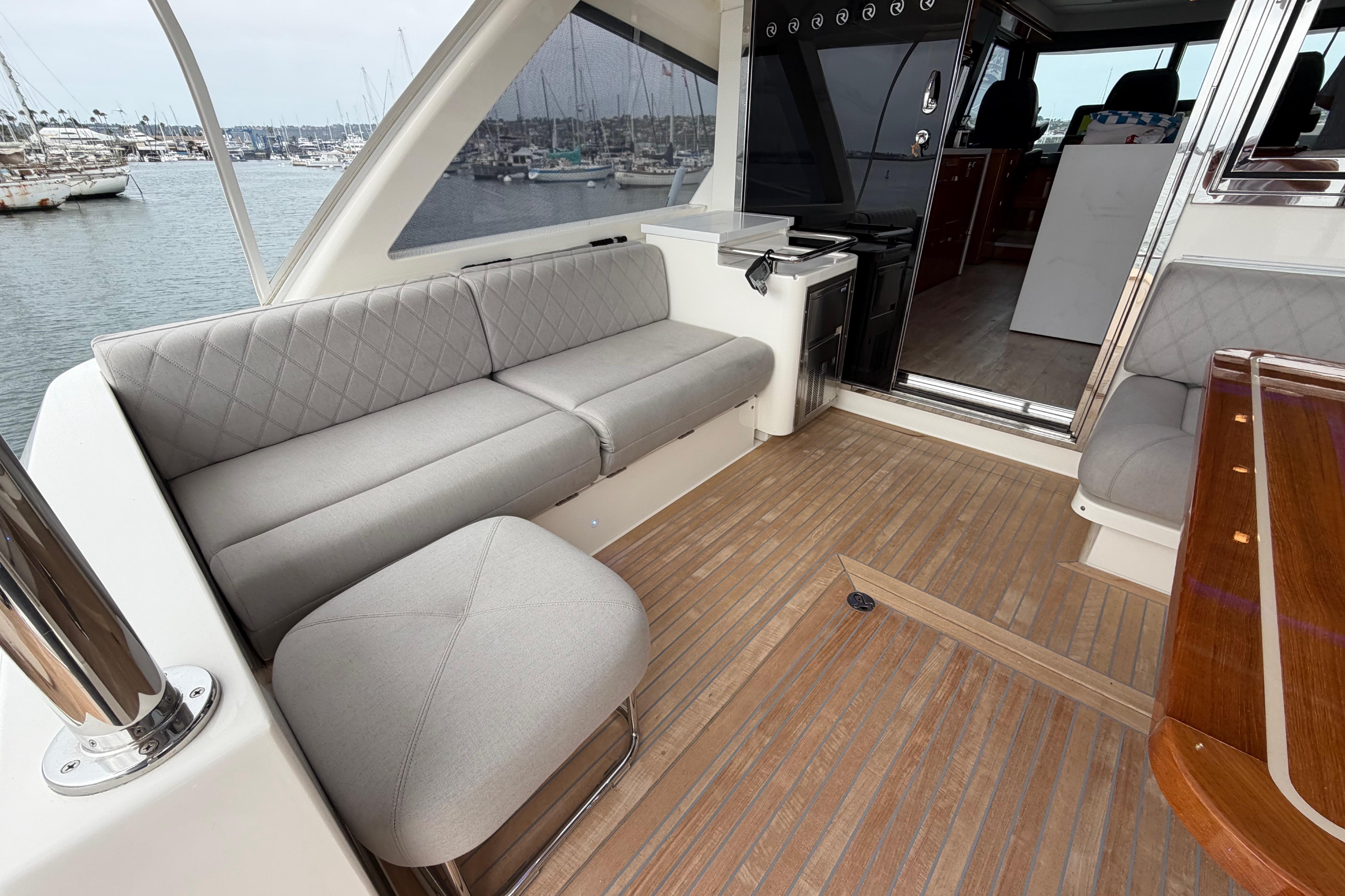 Luxurious 2023 Riviera 645 SUV yacht interior with elegant seating and wooden flooring.