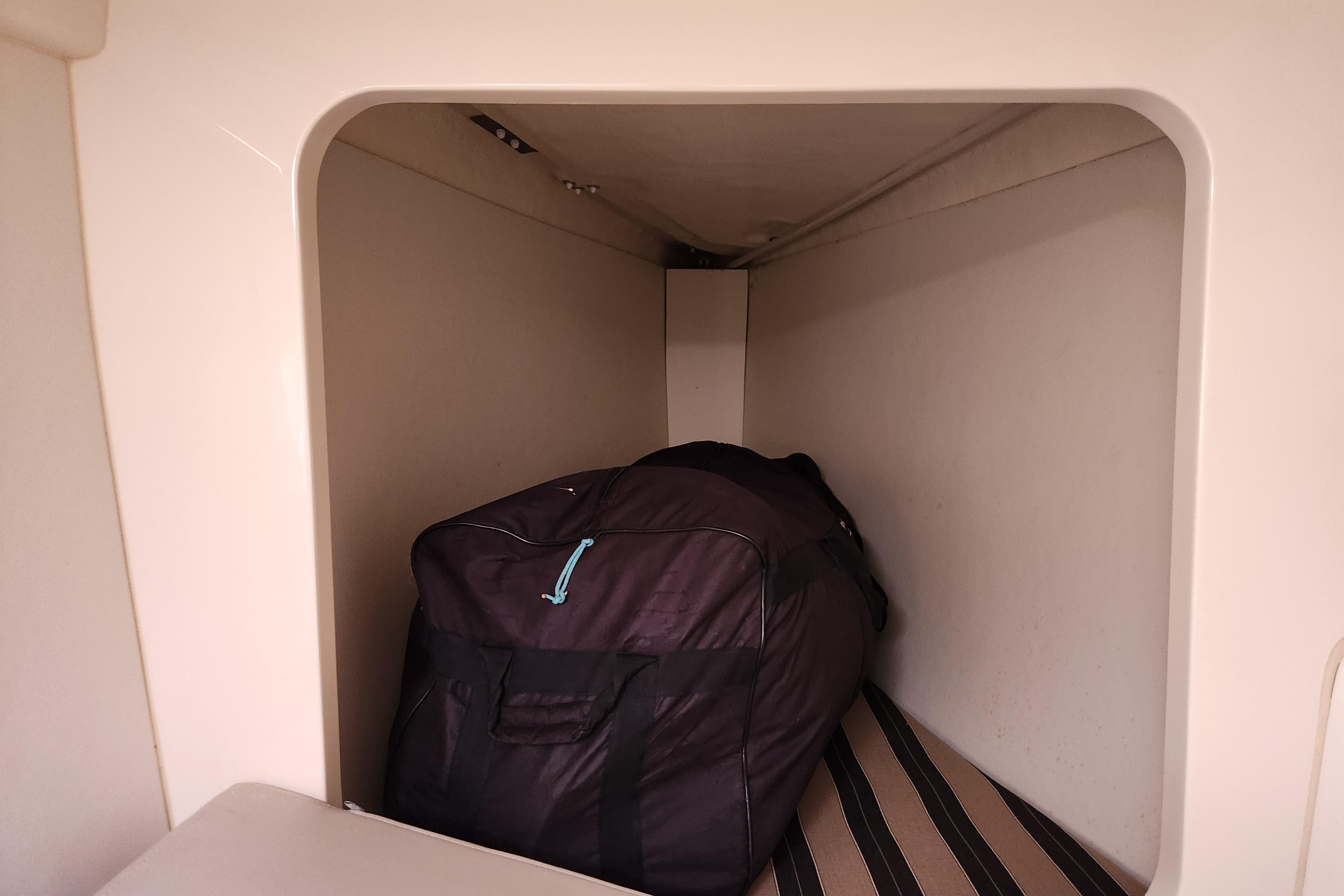 Storage compartment in a 2015 Leopard 44 yacht with a large black bag.