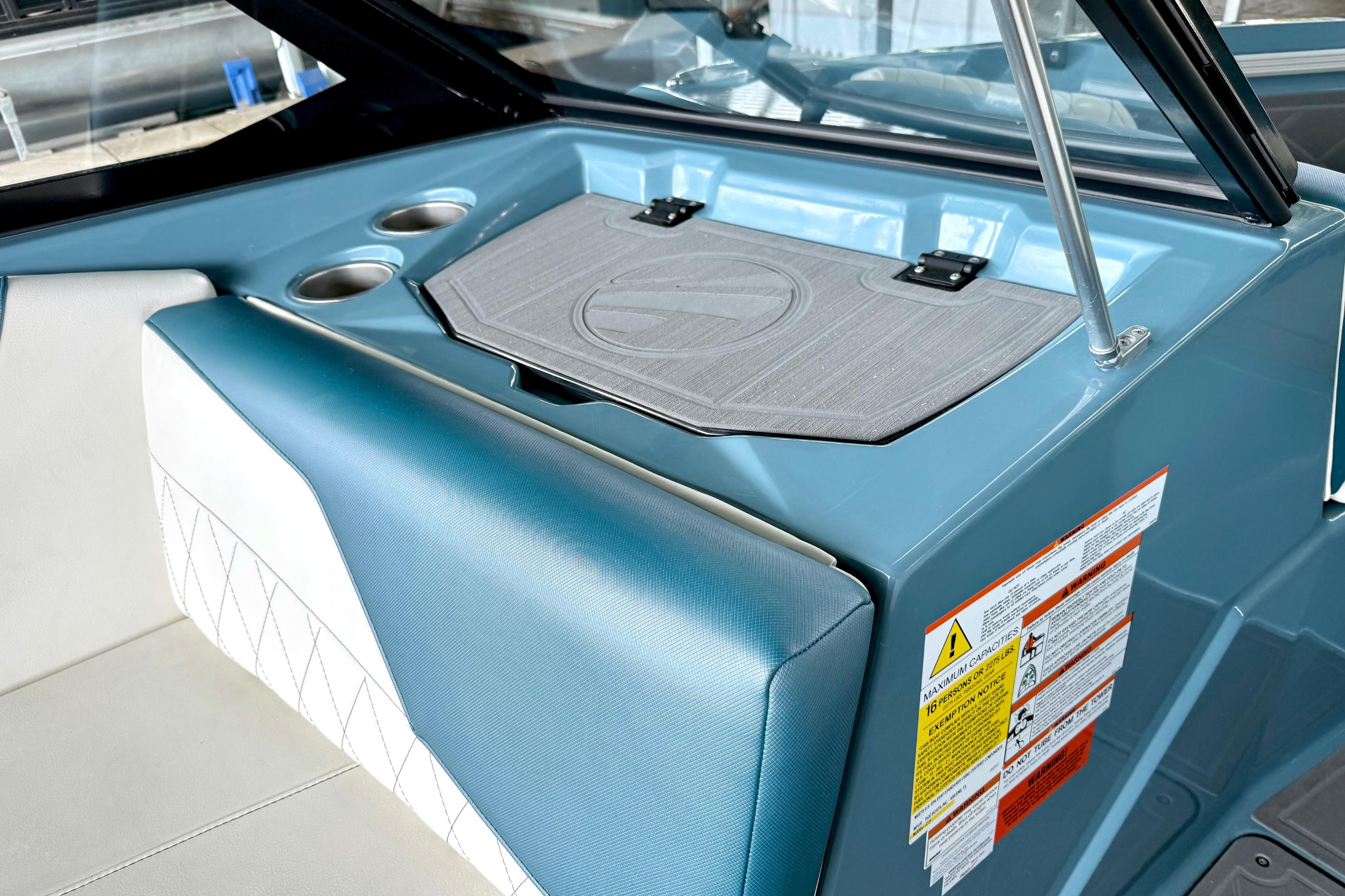 Interior of 2021 Tige Z3 boat featuring blue upholstery and cup holders.