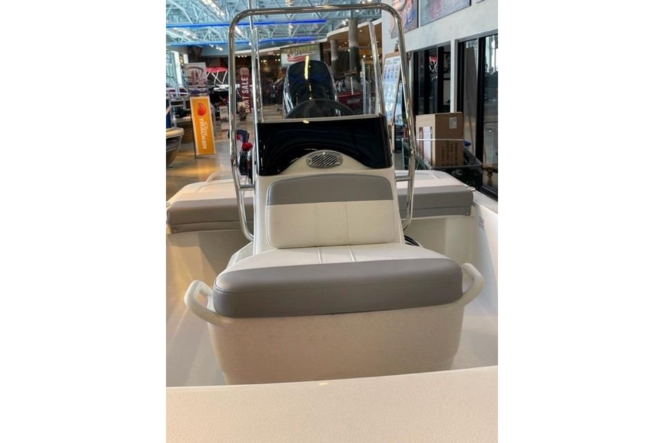 2026 Mako Pro Skiff 13 CC boat interior with seating and console in showroom.