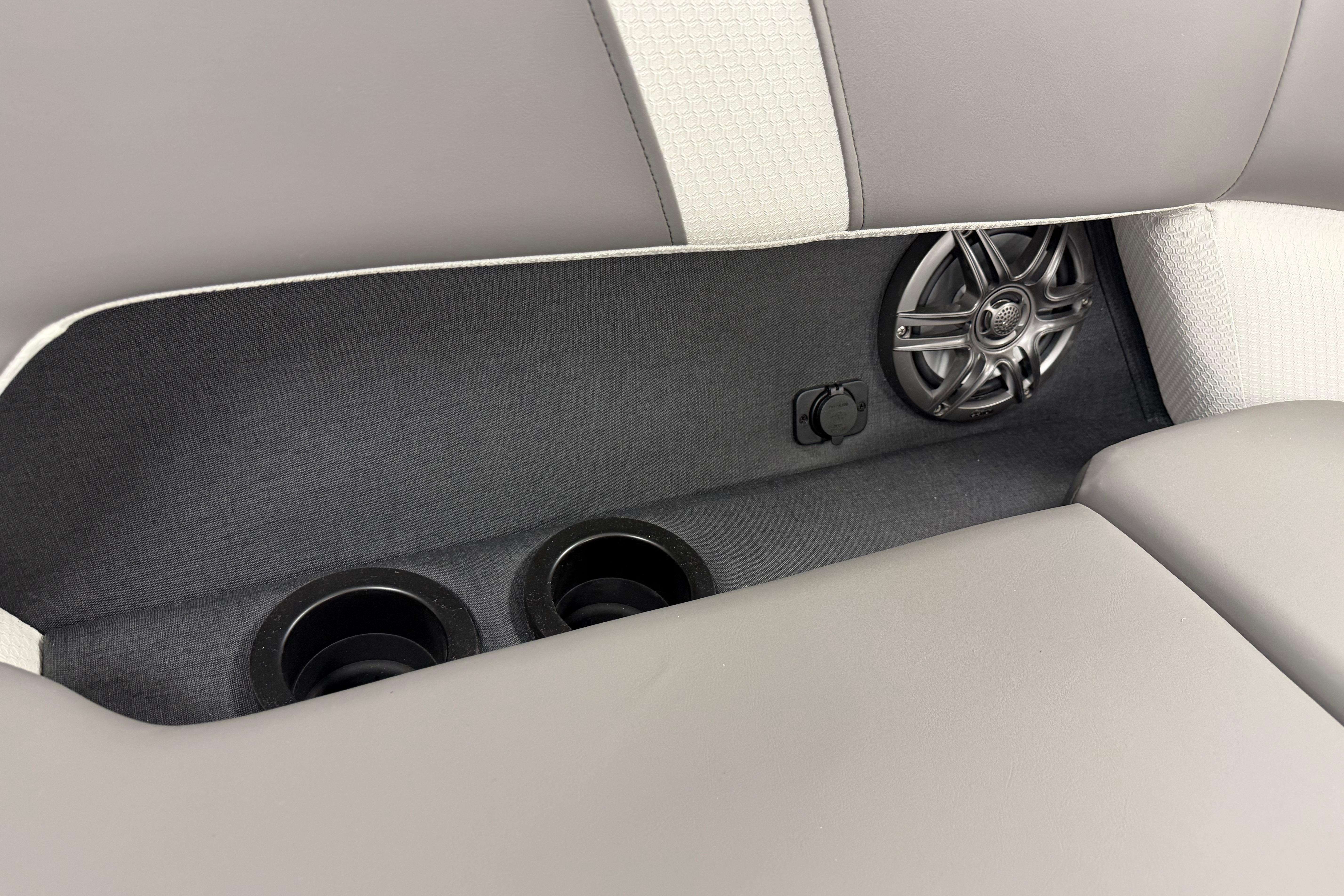 Rear seating area of 2026 Evotti 523QL with cup holders and speaker.