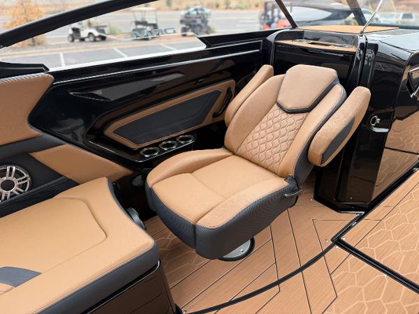 2025 Yamaha Boats 255XD interior with luxurious tan and black seating, modern design.
