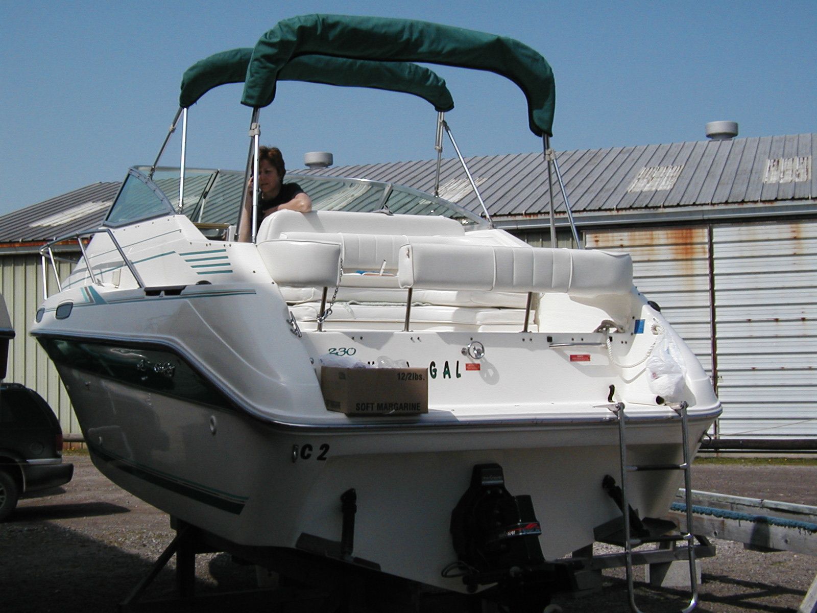 1994 Sea Ray 230 Sundancer boat parked at dock.