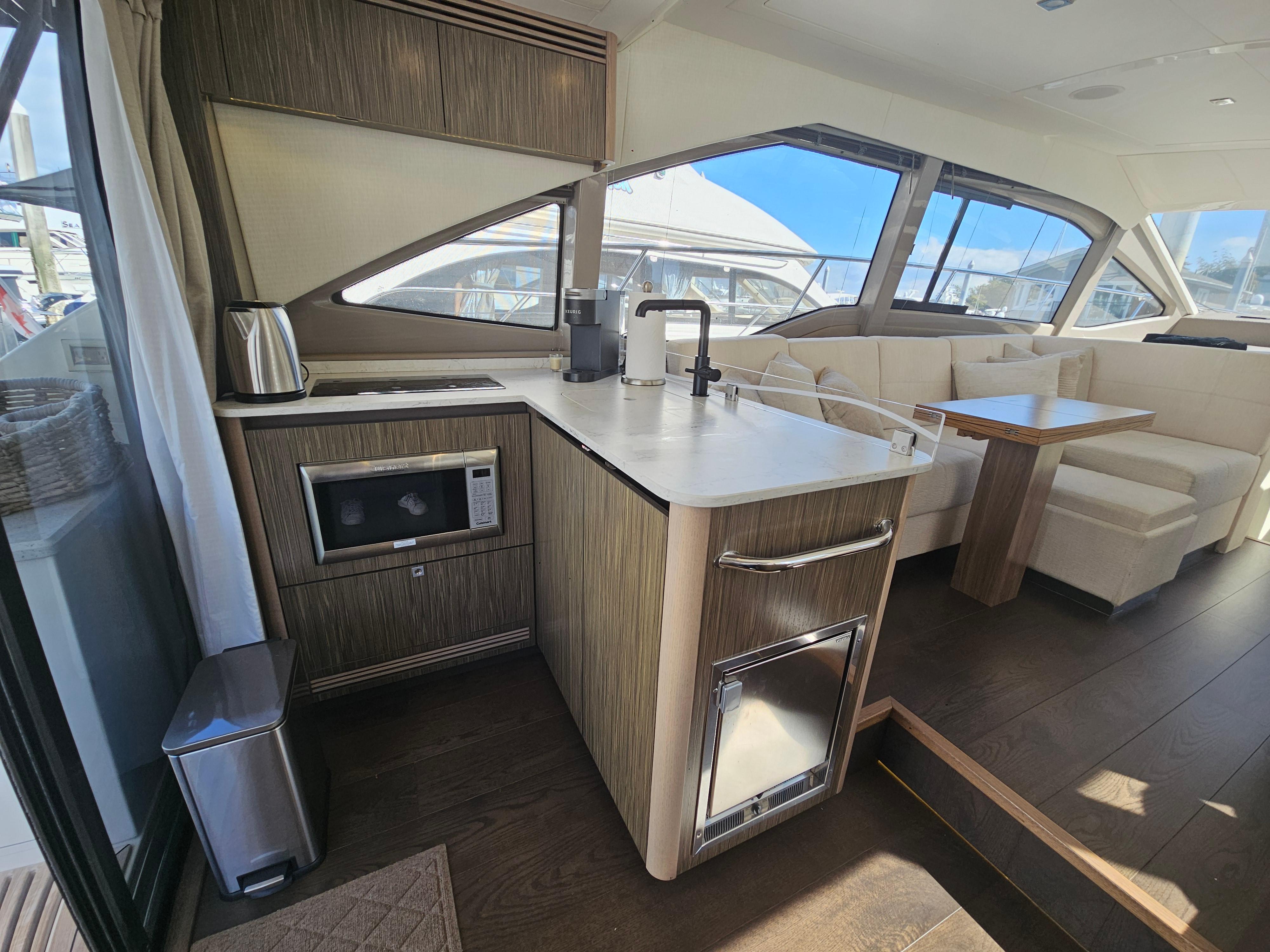 2018 Sea Ray Fly 460 yacht interior with modern kitchen and dining area.