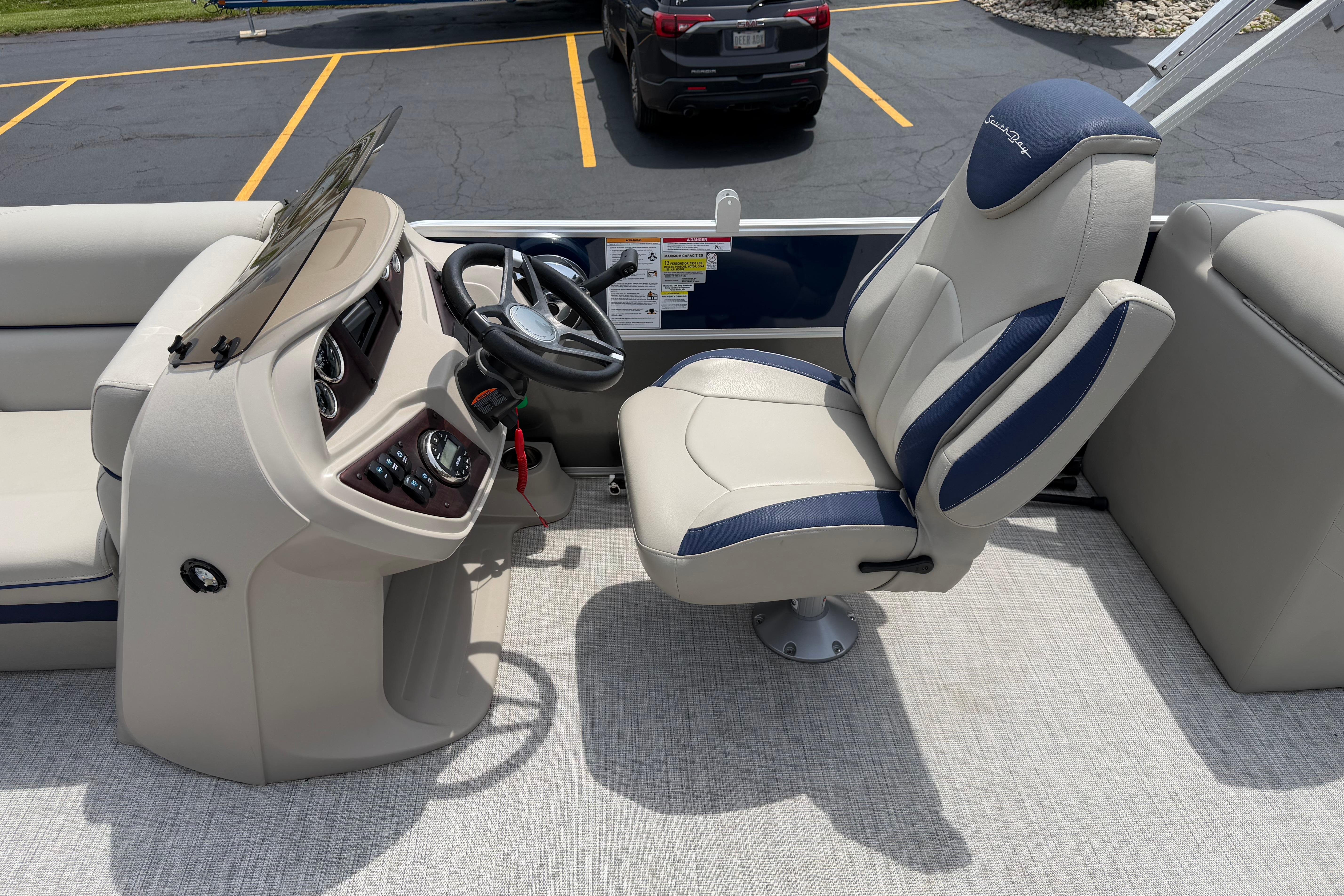 Captain's seat and helm of 2021 South Bay 224RS LE pontoon boat.