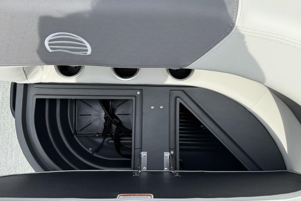 2026 Sun Tracker Bass Buggy 16 XL Select storage compartment with open lid and cup holders.
