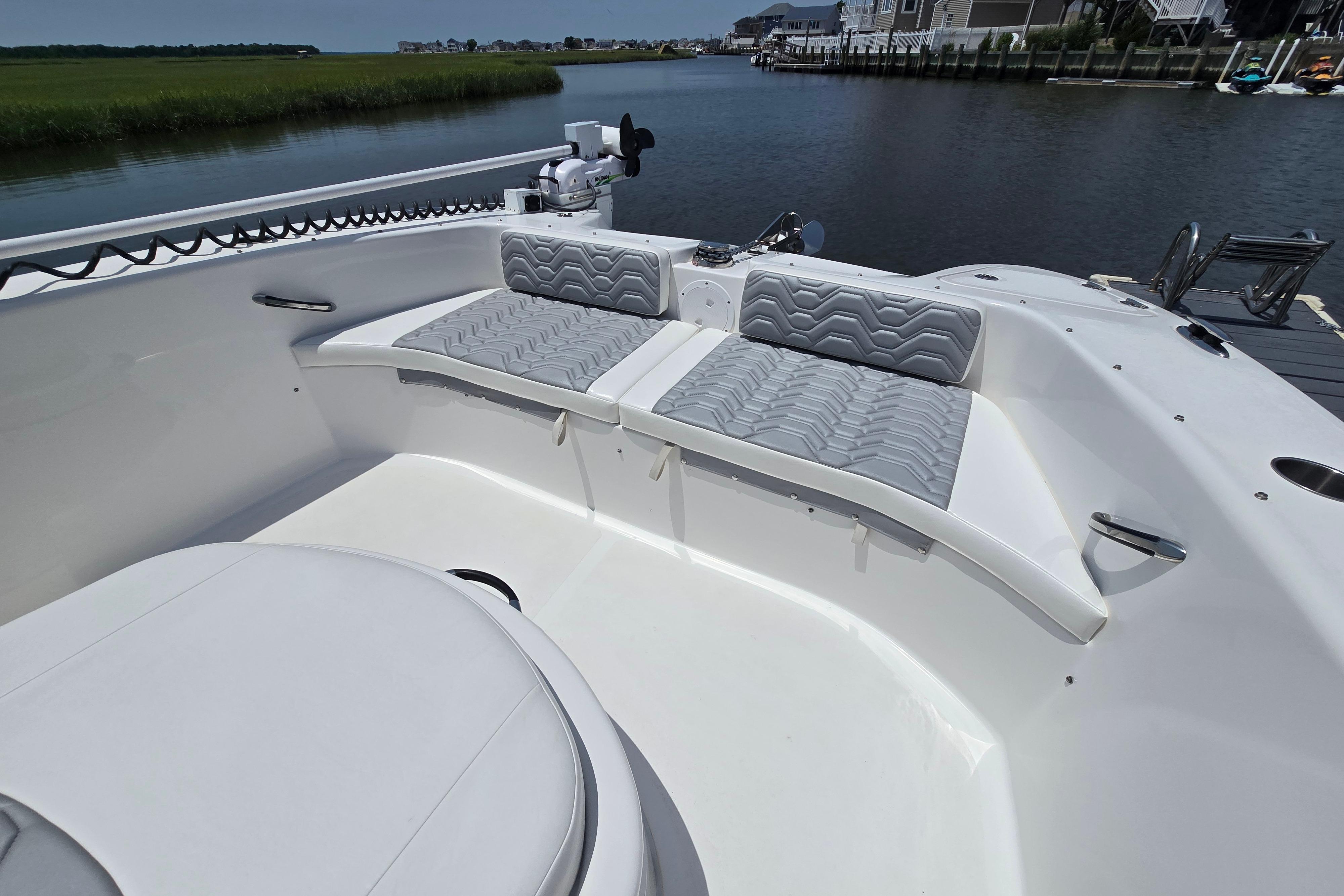 2021 Twin Vee 280 GFX CC boat interior with cushioned seating by the water.