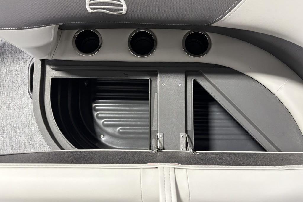 Storage compartment and cup holders in 2026 Sun Tracker Bass Buggy 18 DLX boat.