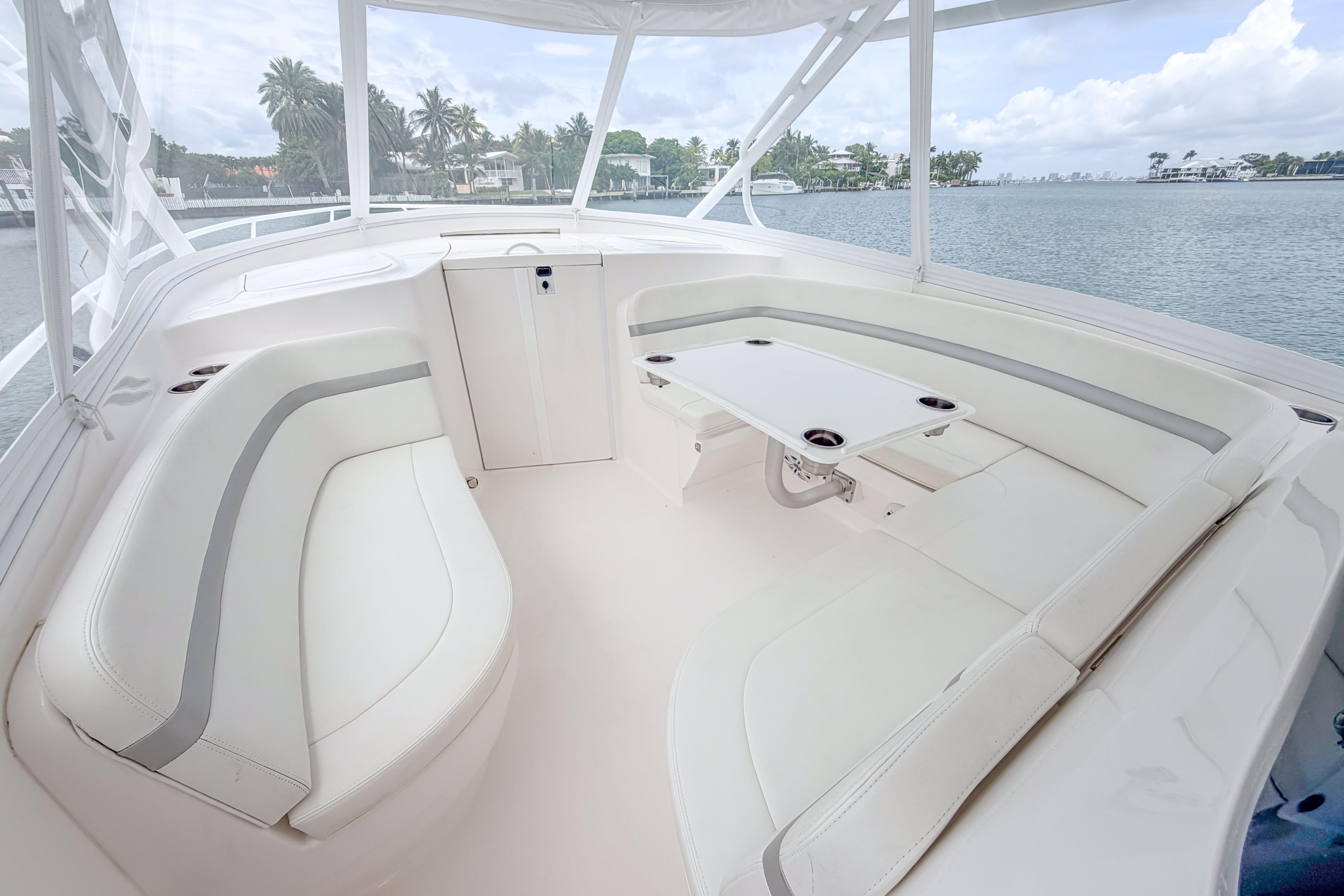 Luxurious seating area on 2021 Intrepid 409 Valor boat, featuring sleek white upholstery.