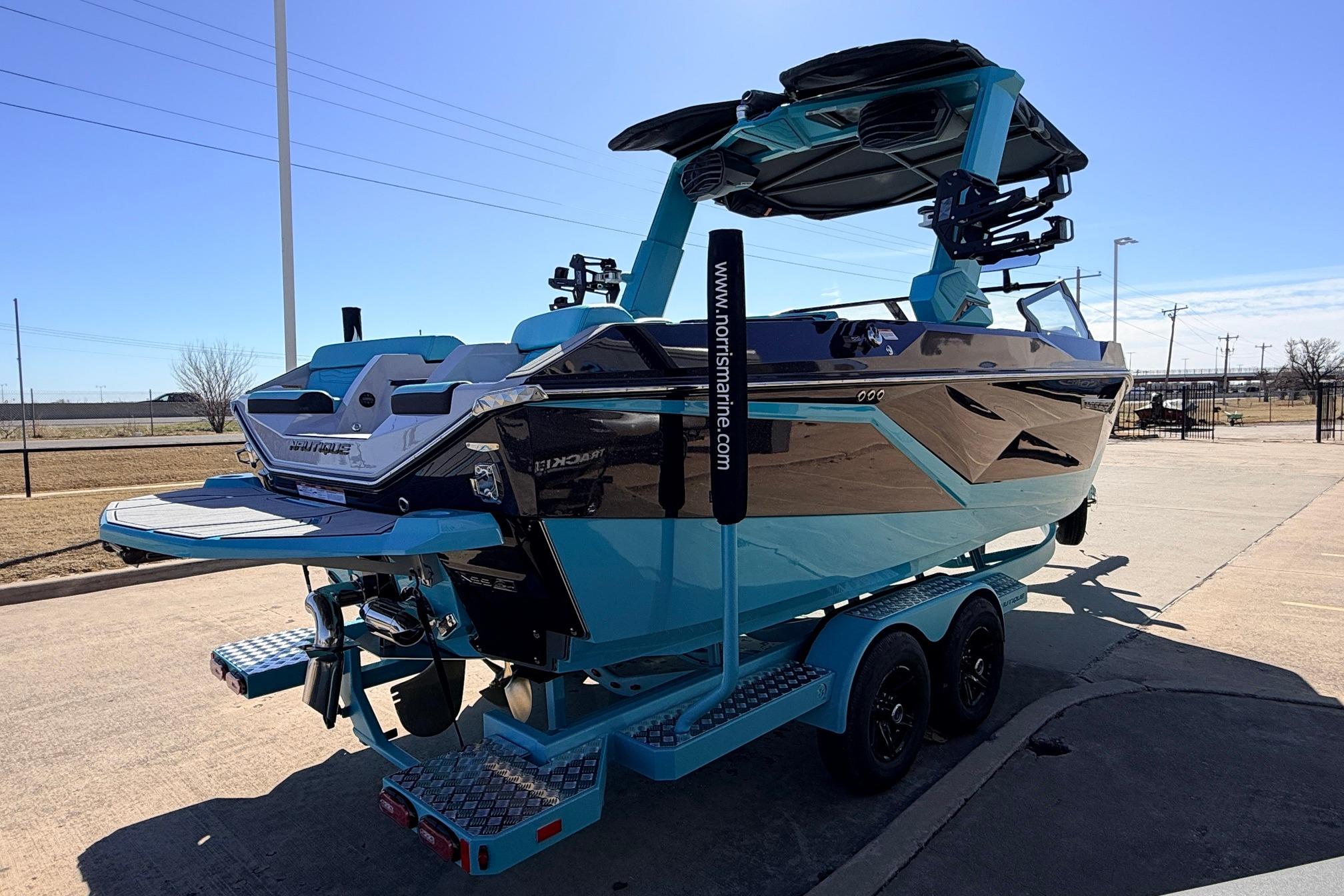 2026 Nautique Super Air Nautique G23 boat on trailer, parked outdoors.