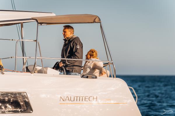 Couple enjoying a cruise on a 2025 Nautitech 44 Open catamaran.