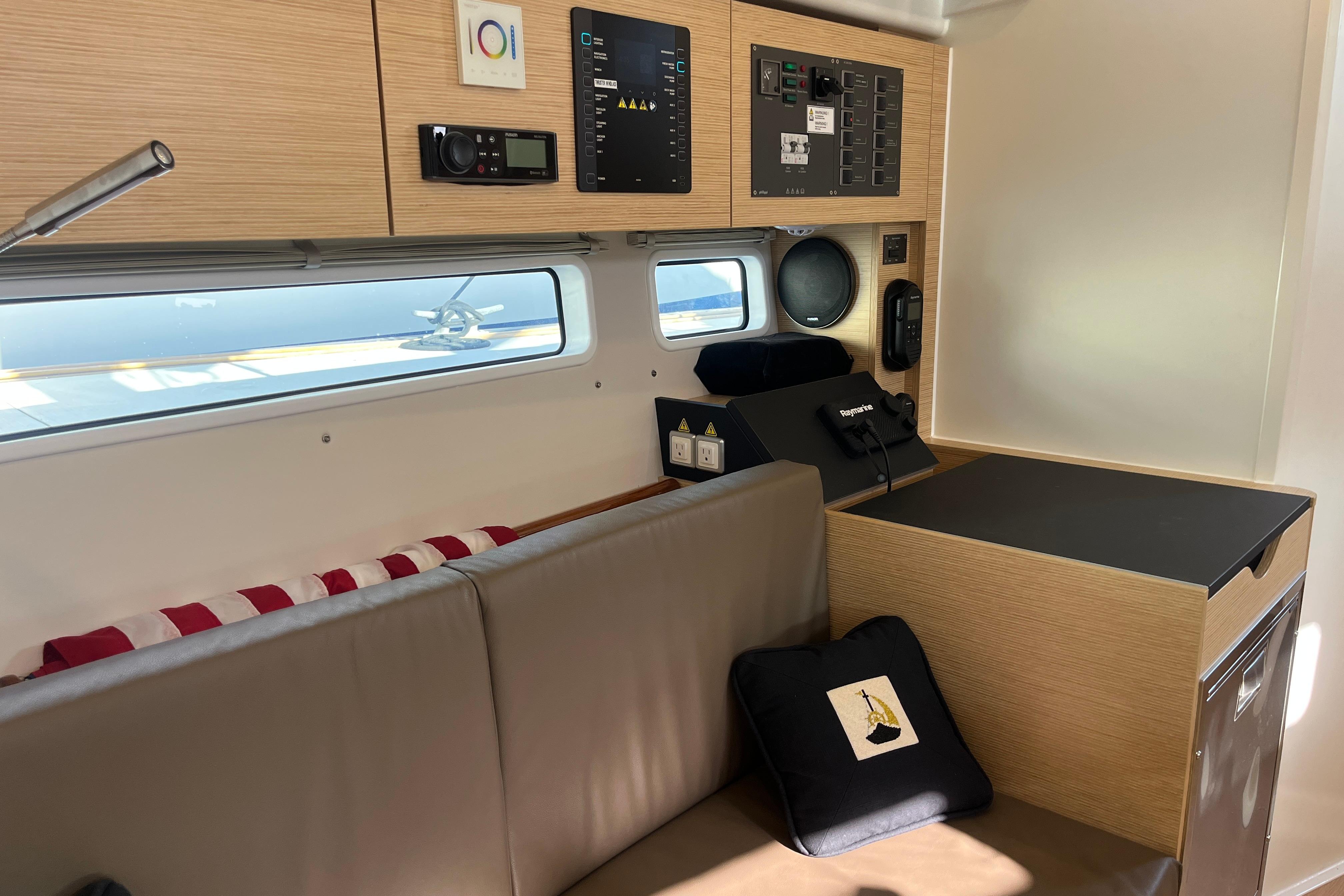 2025 Hanse 360 yacht interior with control panel, seating, and modern design elements.