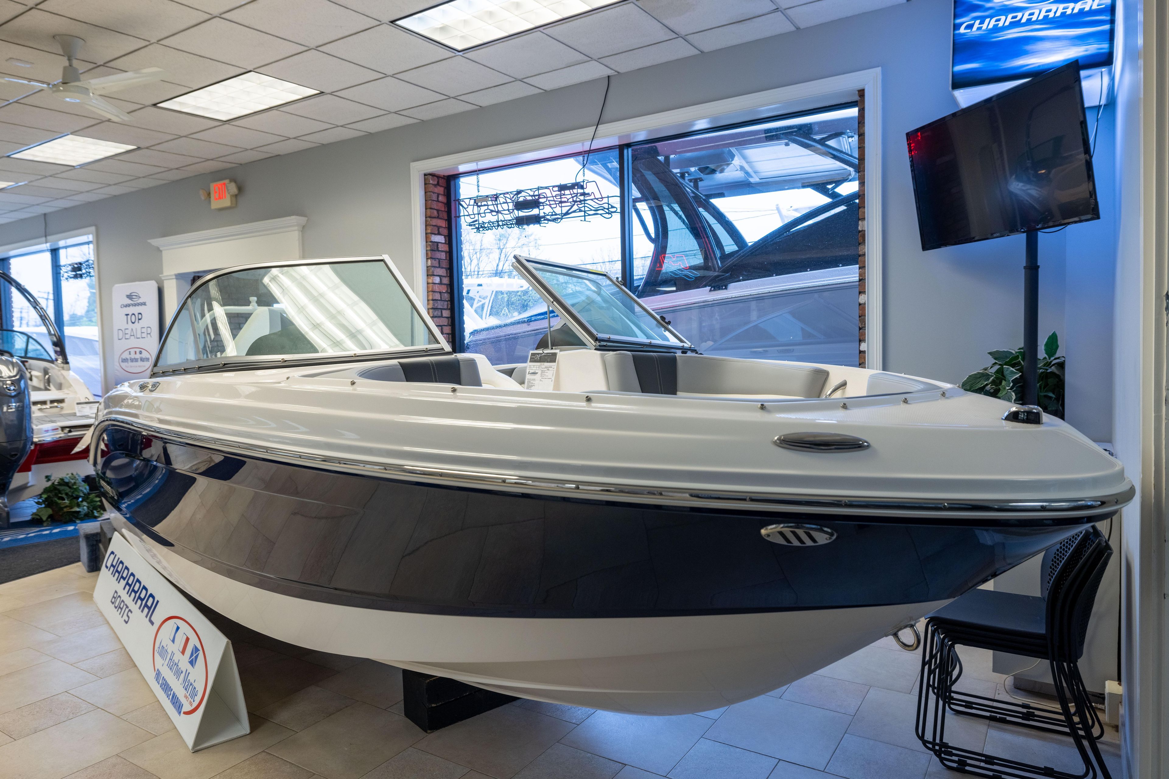 2024 Chaparral 19 SSi OB boat displayed in a showroom, highlighting sleek design and features.