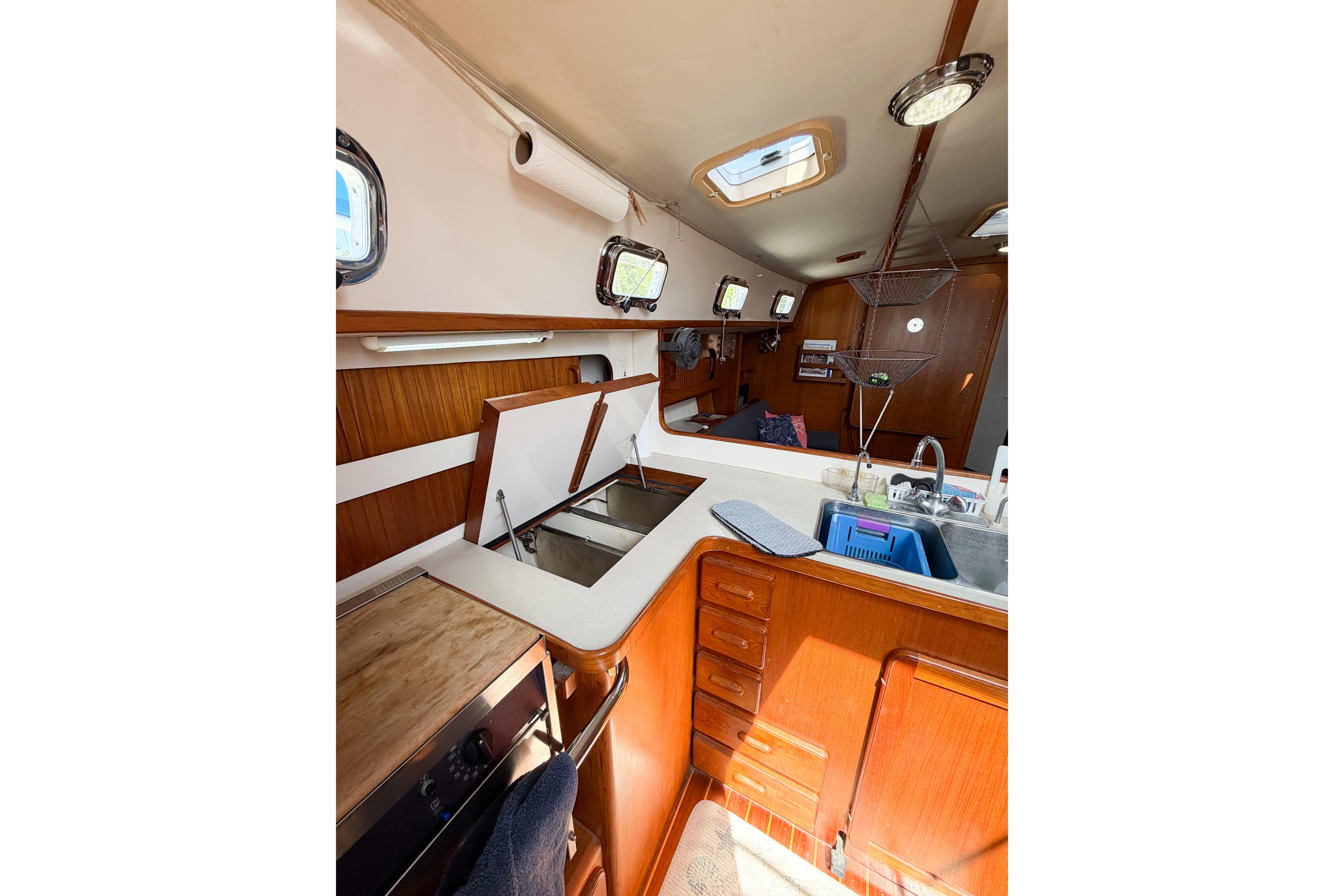 Interior of 2001 Caliber 40LRC sailboat featuring kitchen area with wooden cabinetry.