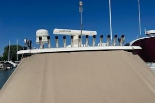2013 Tiara Yachts 3100 Open with Garmin equipment, docked under clear blue sky.