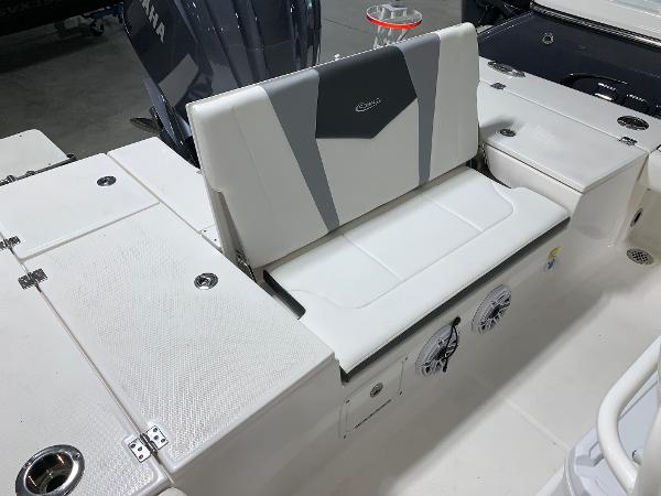 2024 Robalo 246 Cayman boat seating area with storage compartments.