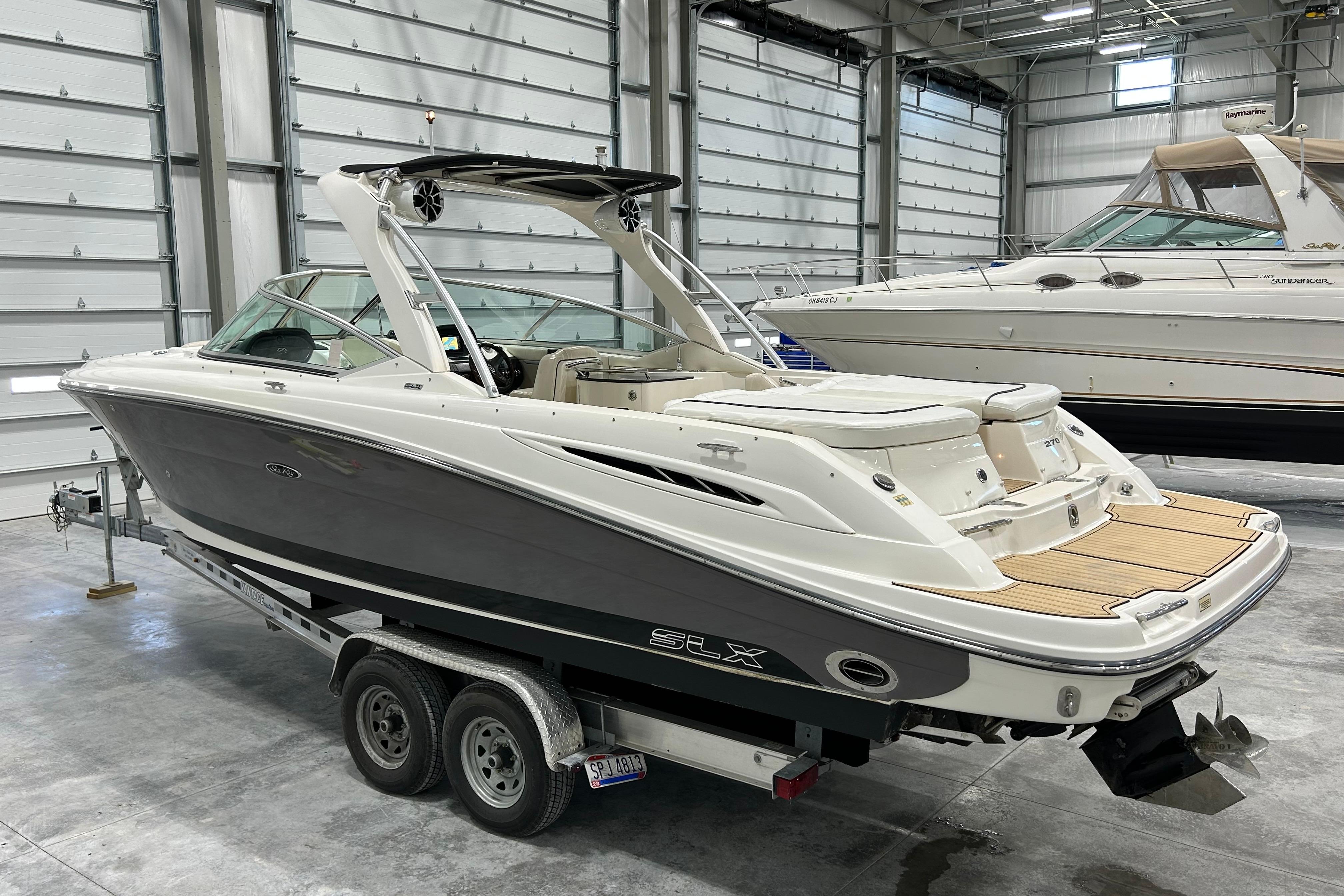2006 Sea Ray 270 SLX boat on trailer in indoor storage facility.