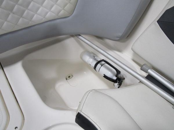 2017 Larson 292 LXI boat interior with fire extinguisher and white seating.