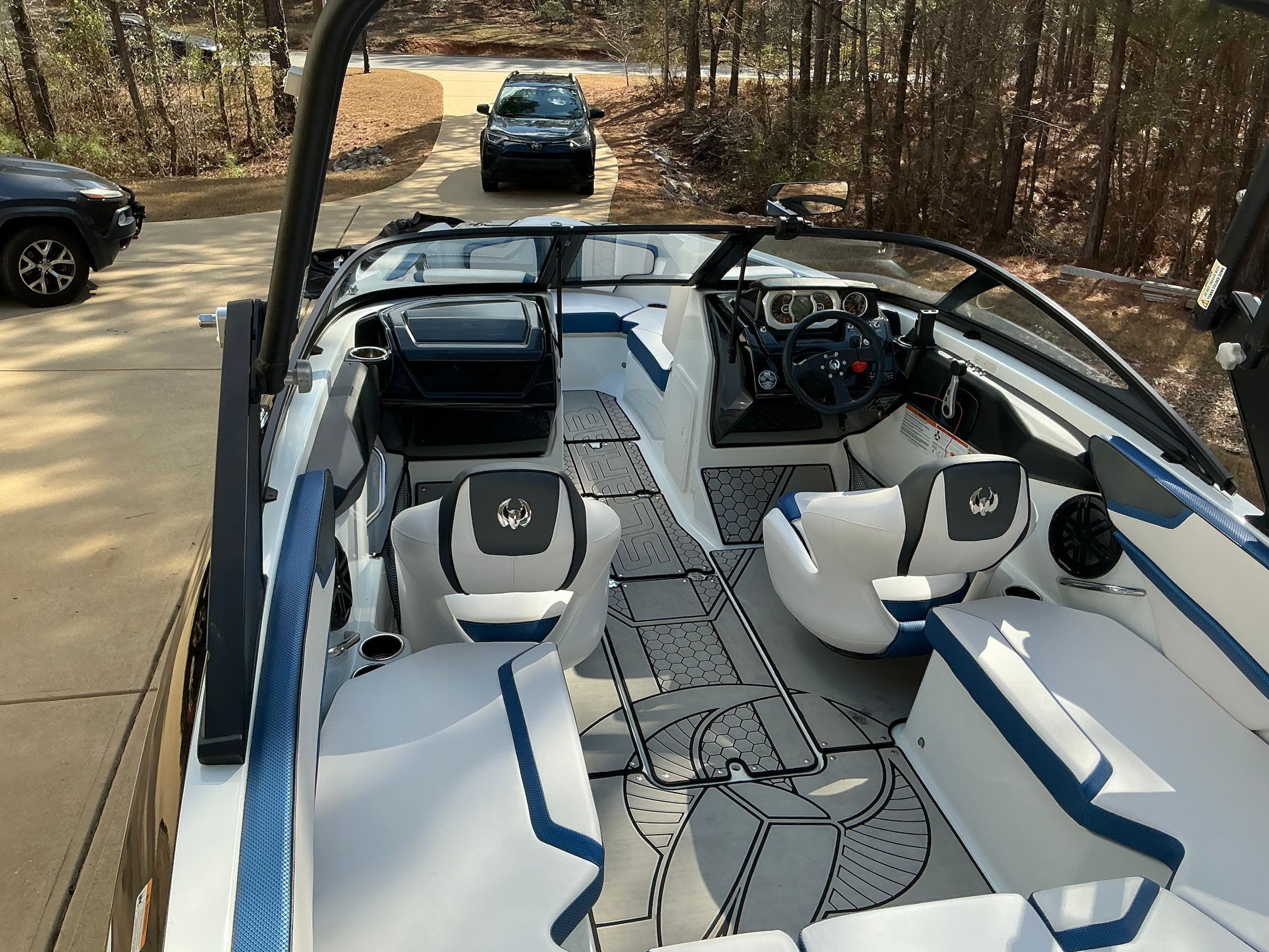 Interior view of a 2021 Scarab 215 ID boat on a driveway.