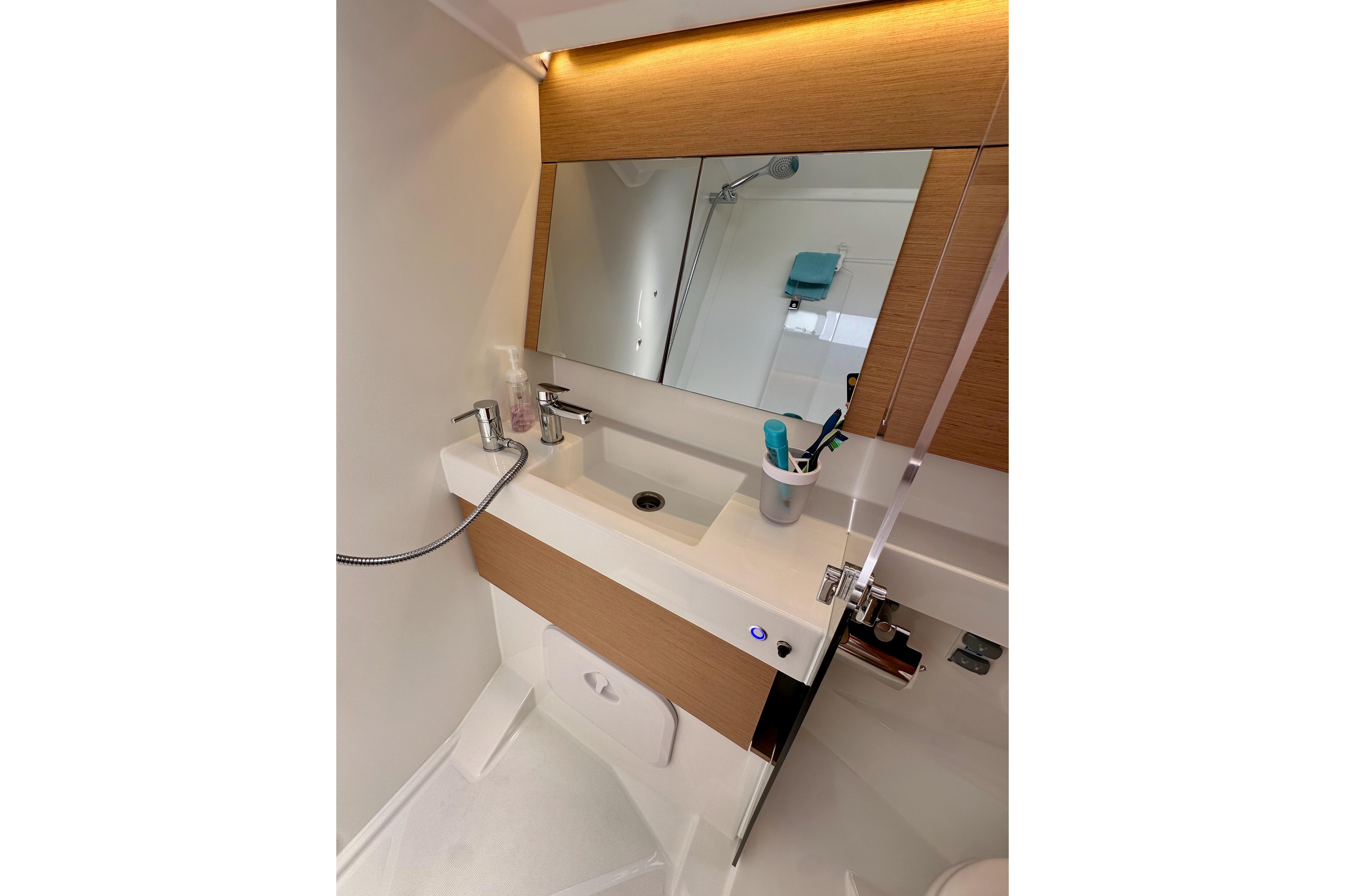2024 Jeanneau Sun Odyssey 410 bathroom with modern sink and mirror.