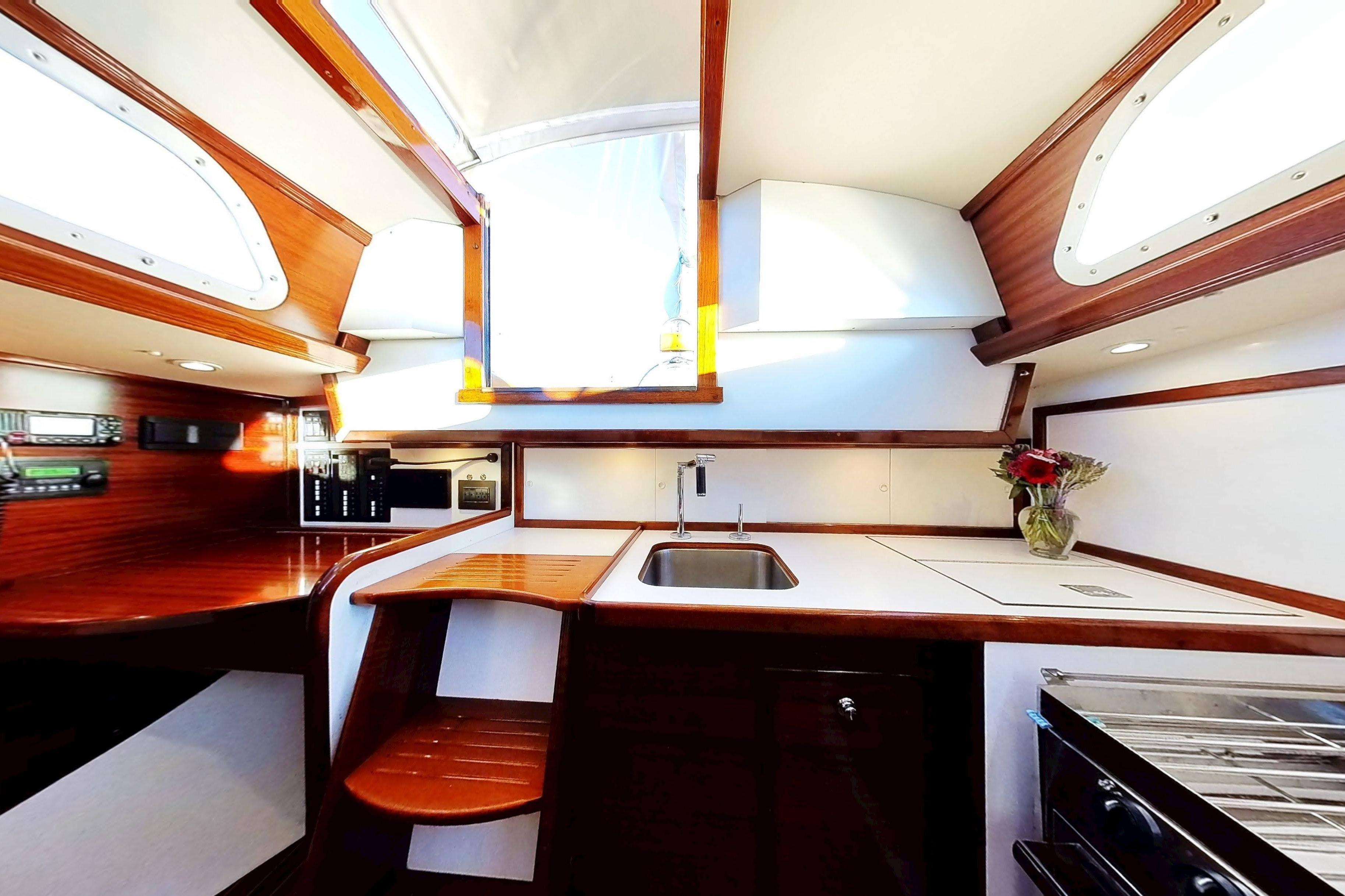 Interior of a 1970 Hinckley Bermuda 40 sailboat, featuring a modern kitchen area.