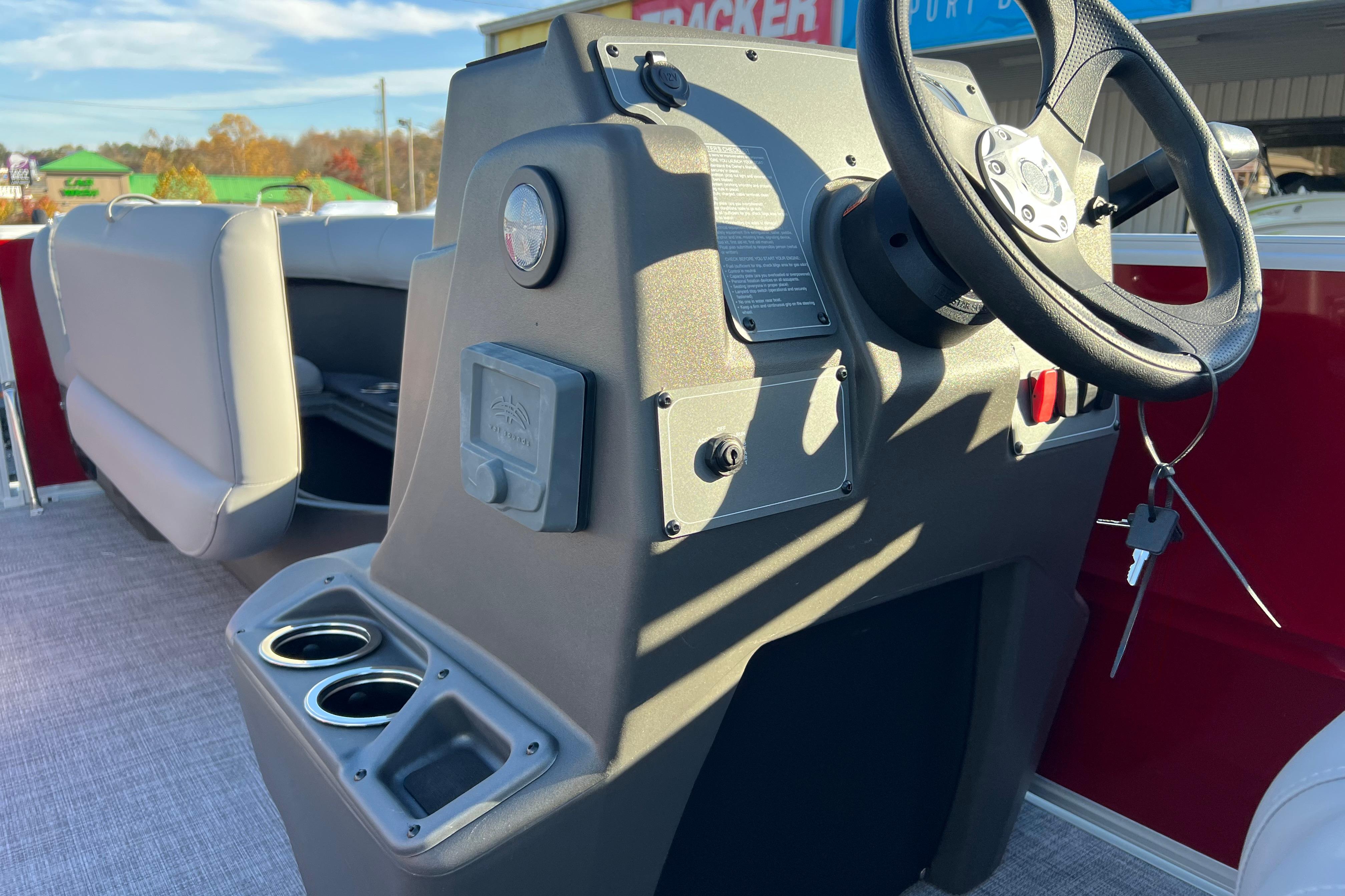 2026 Sun Tracker Party Barge 16 DLX steering console with cup holders and key ignition.