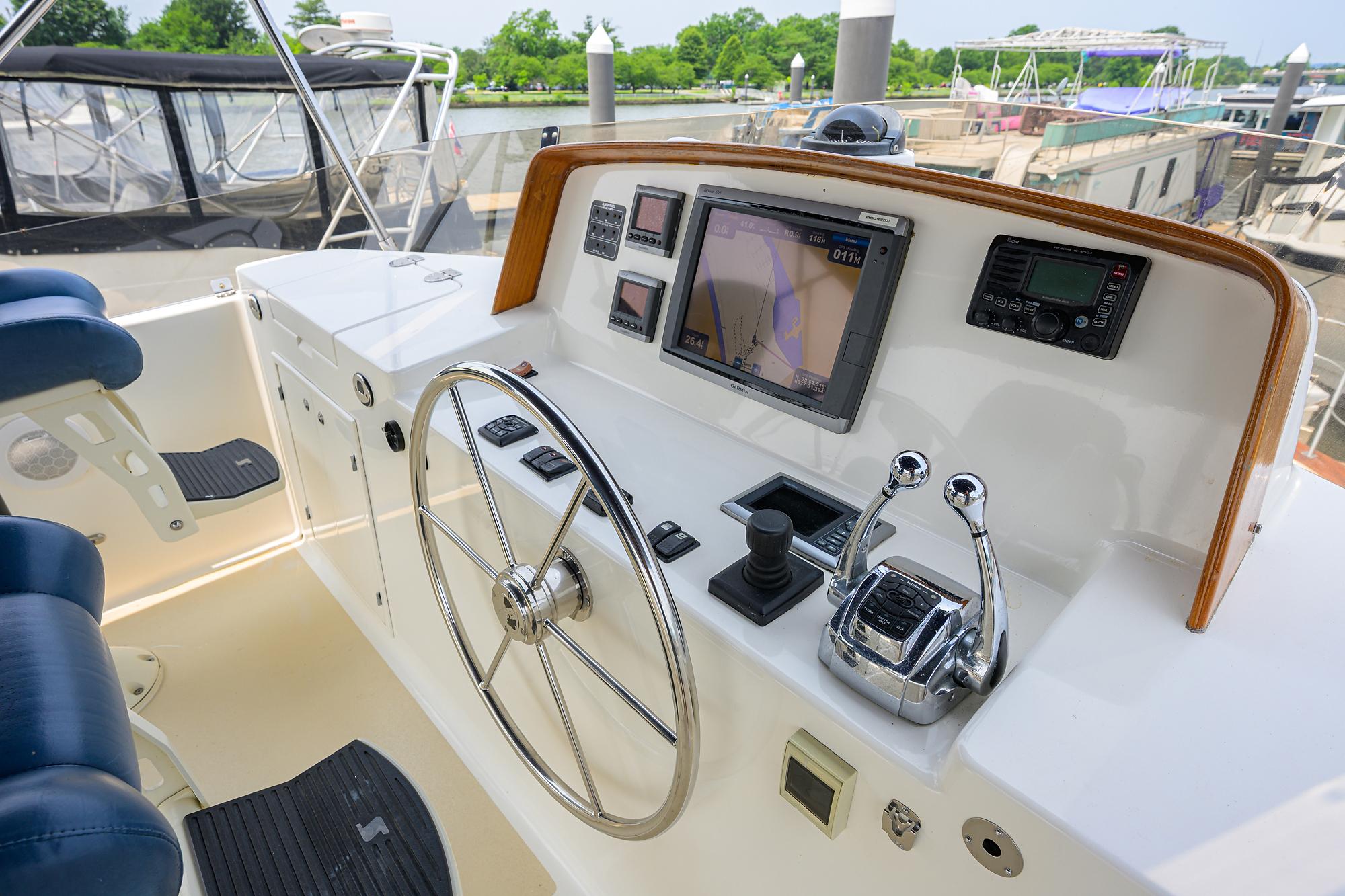 Helm of 2011 Grand Banks 41 Europa yacht with navigation controls and steering wheel.