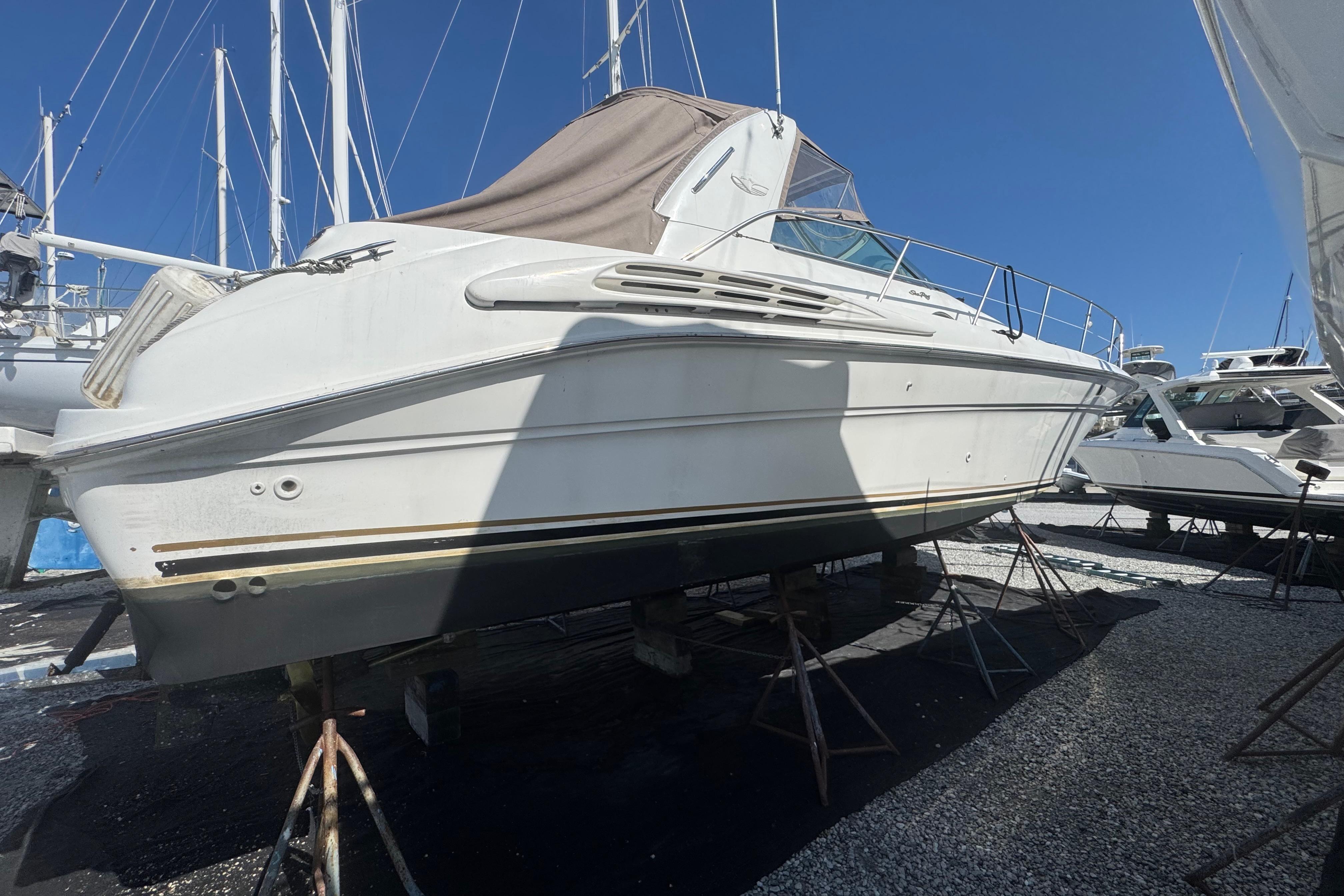1999 Sea Ray Sundancer 400 yacht on stands, under clear blue sky.