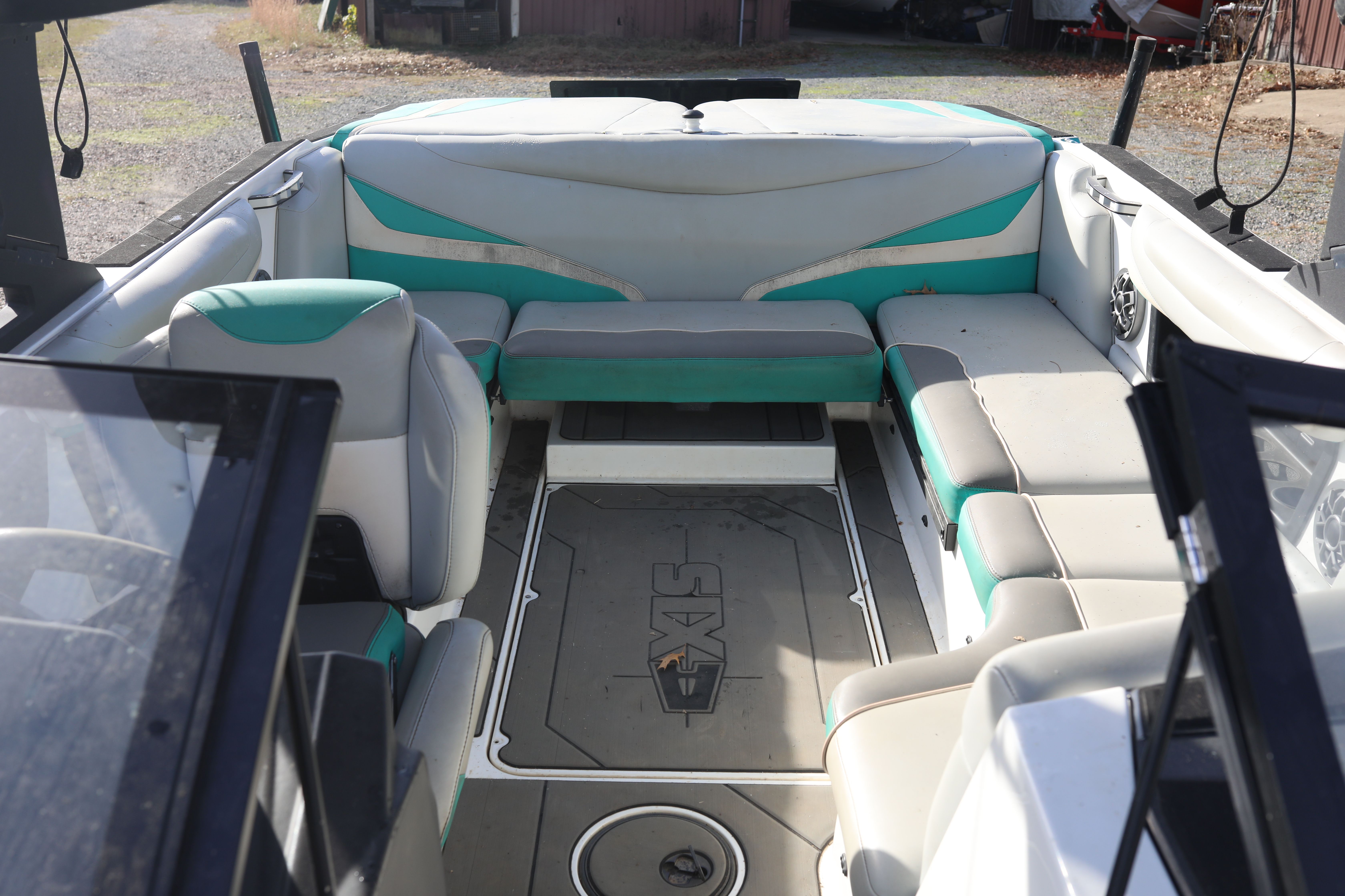 Interior of a 2019 Axis T22 boat with gray and green seating.