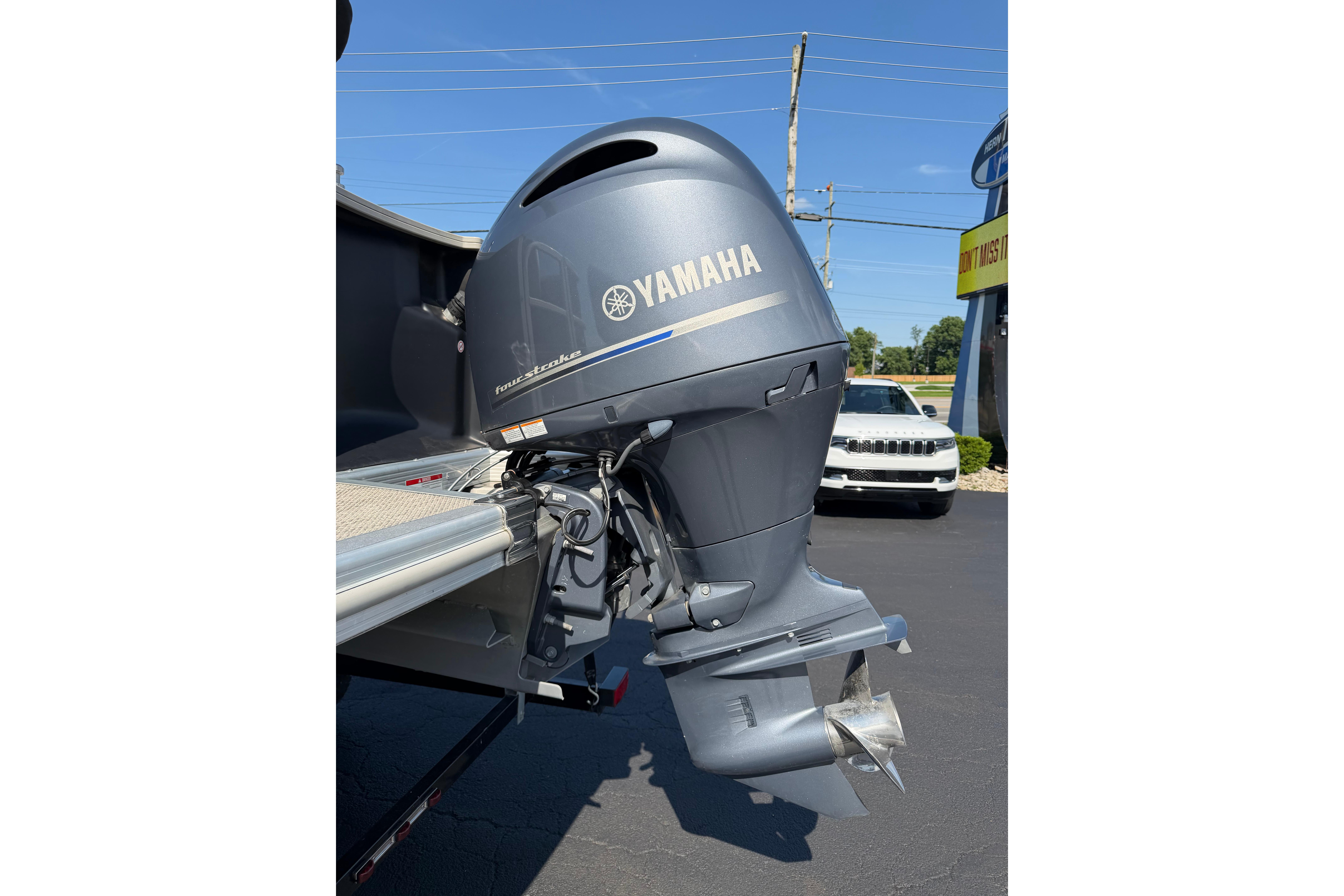 Yamaha outboard motor on a 2018 Bennington 21 SF boat, parked outdoors.